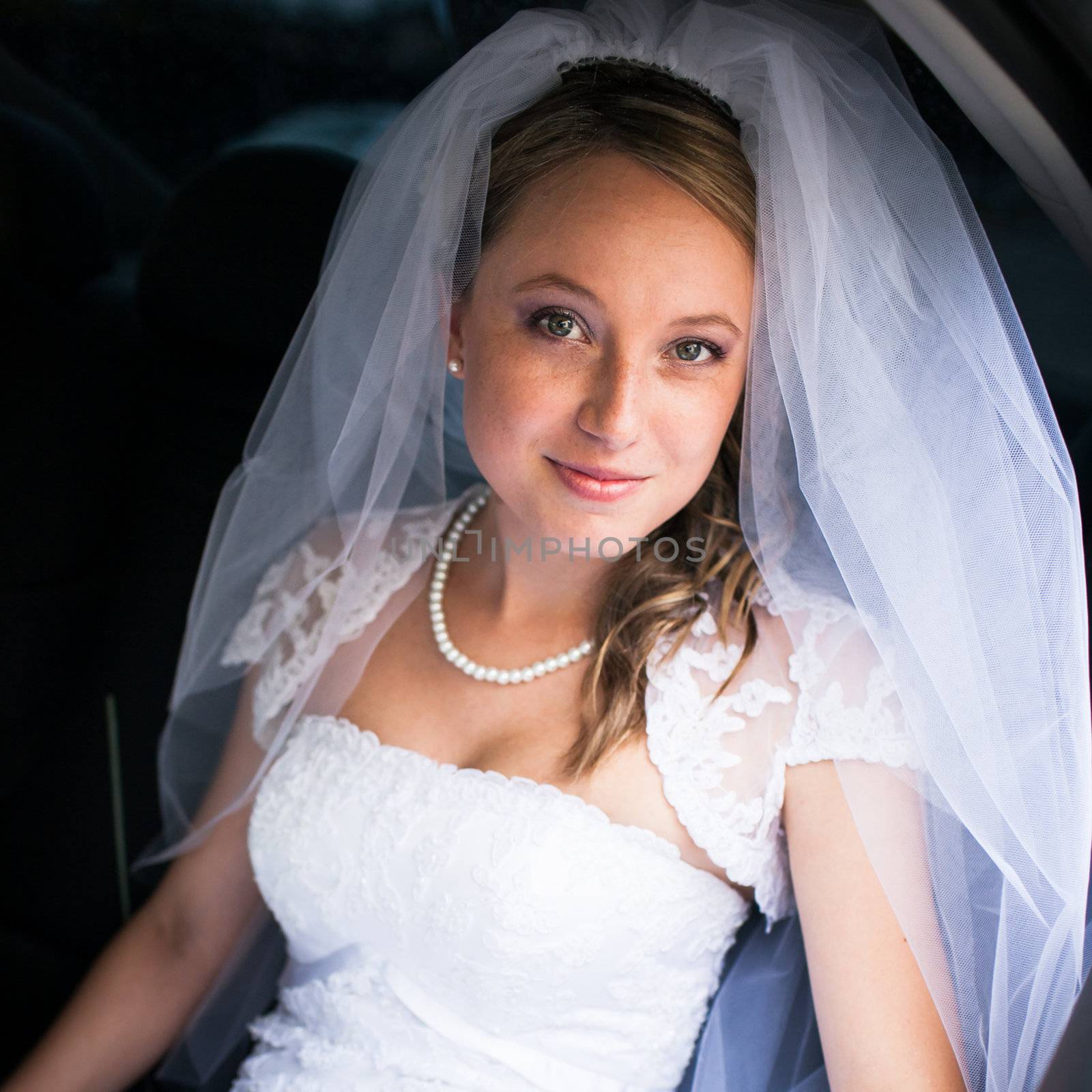 Portrait of a beautiful young bride waiting in the car by viktor_cap