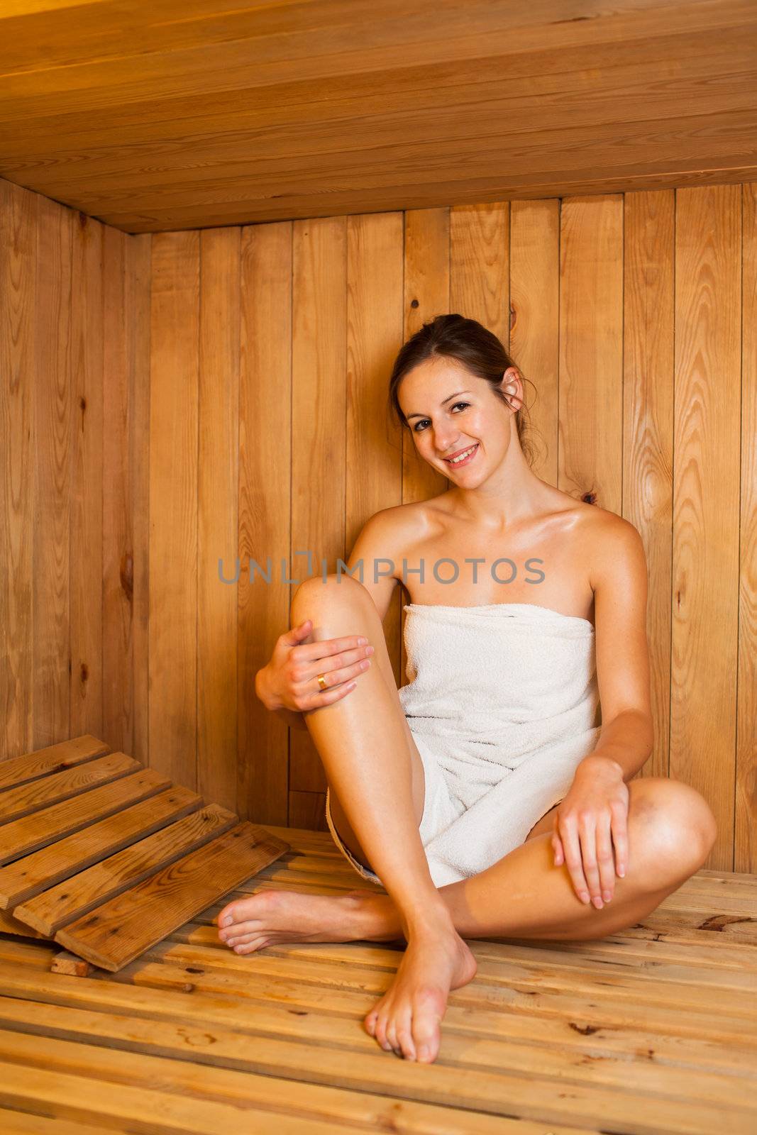 Young woman relaxing in a sauna