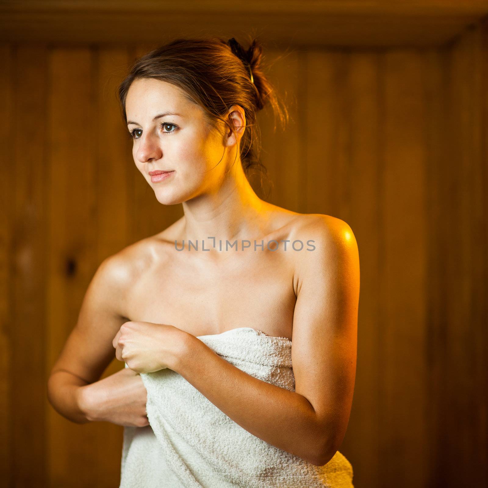 Young woman relaxing in a sauna by viktor_cap