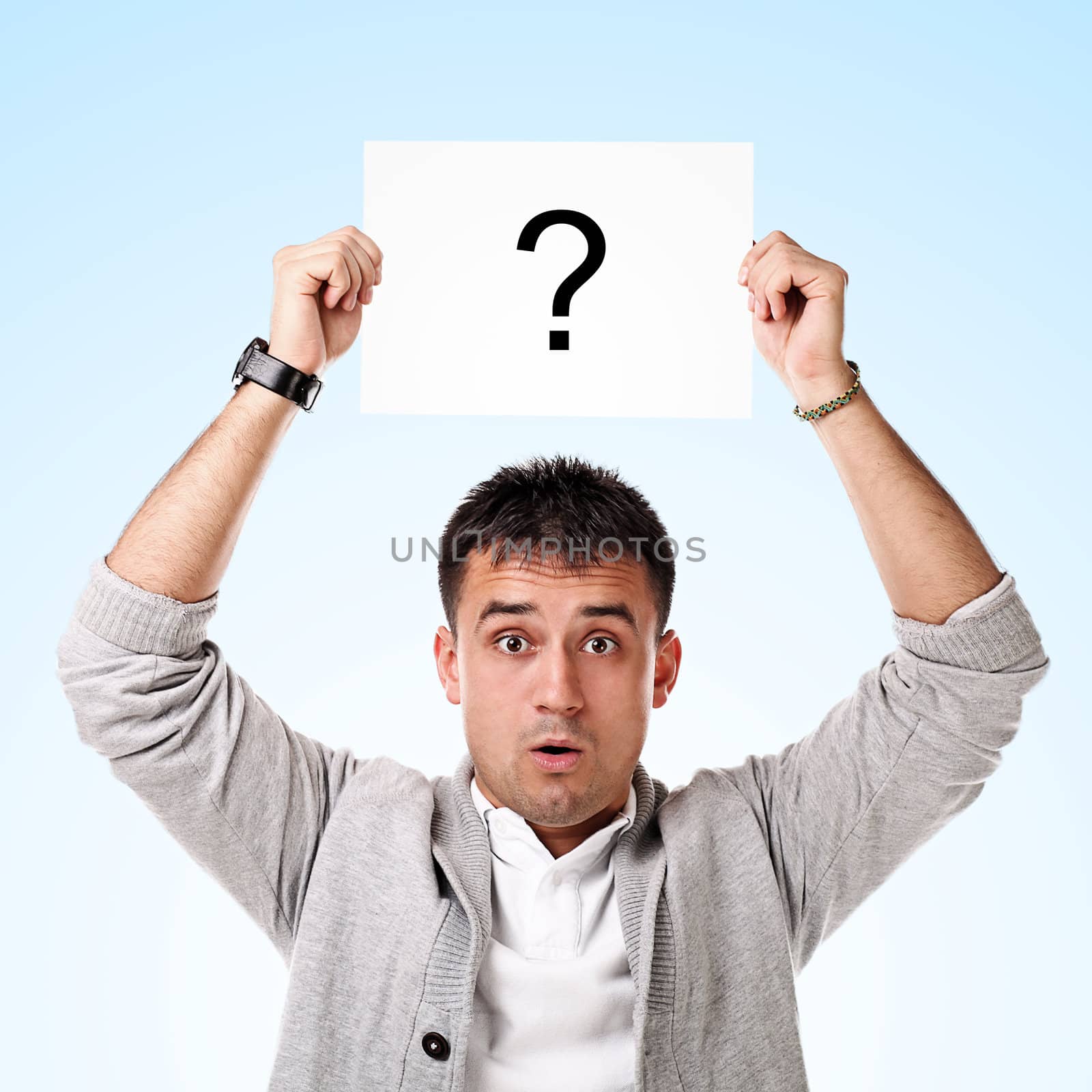 Young handsome man holding blank board ready for text on white background