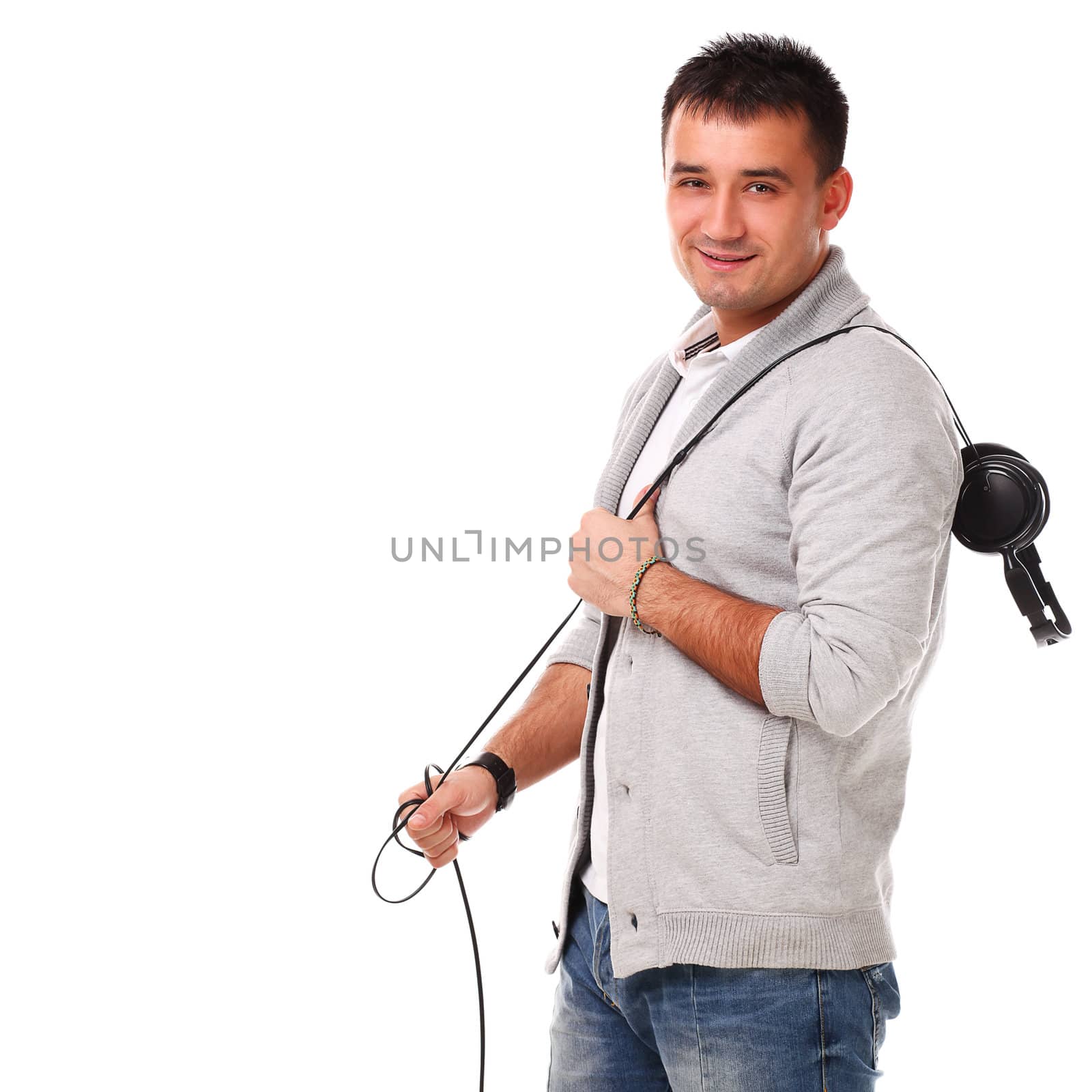 Young caucasian handsome man listening music isolated over white background