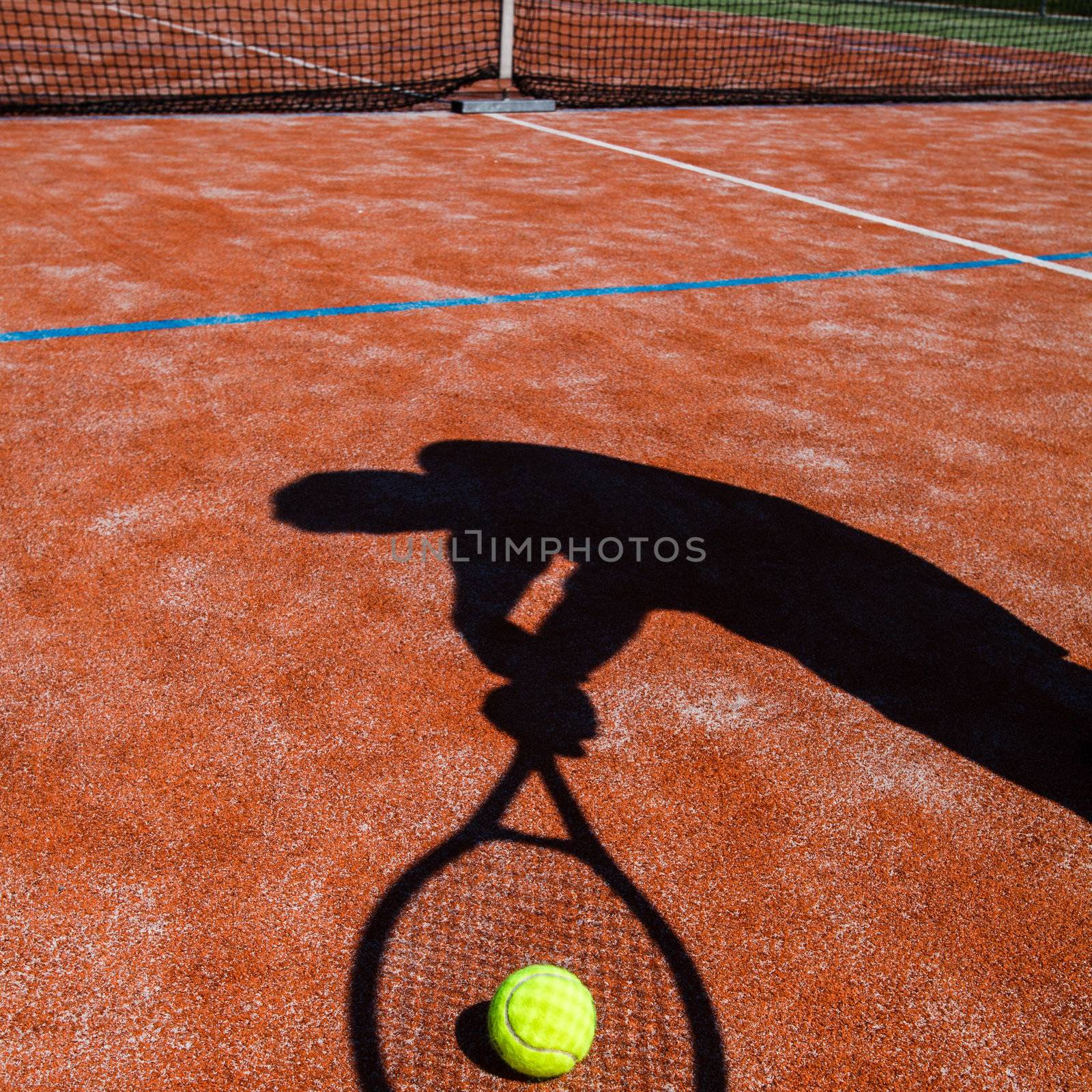 shadow of a tennis player in action on a tennis court by viktor_cap