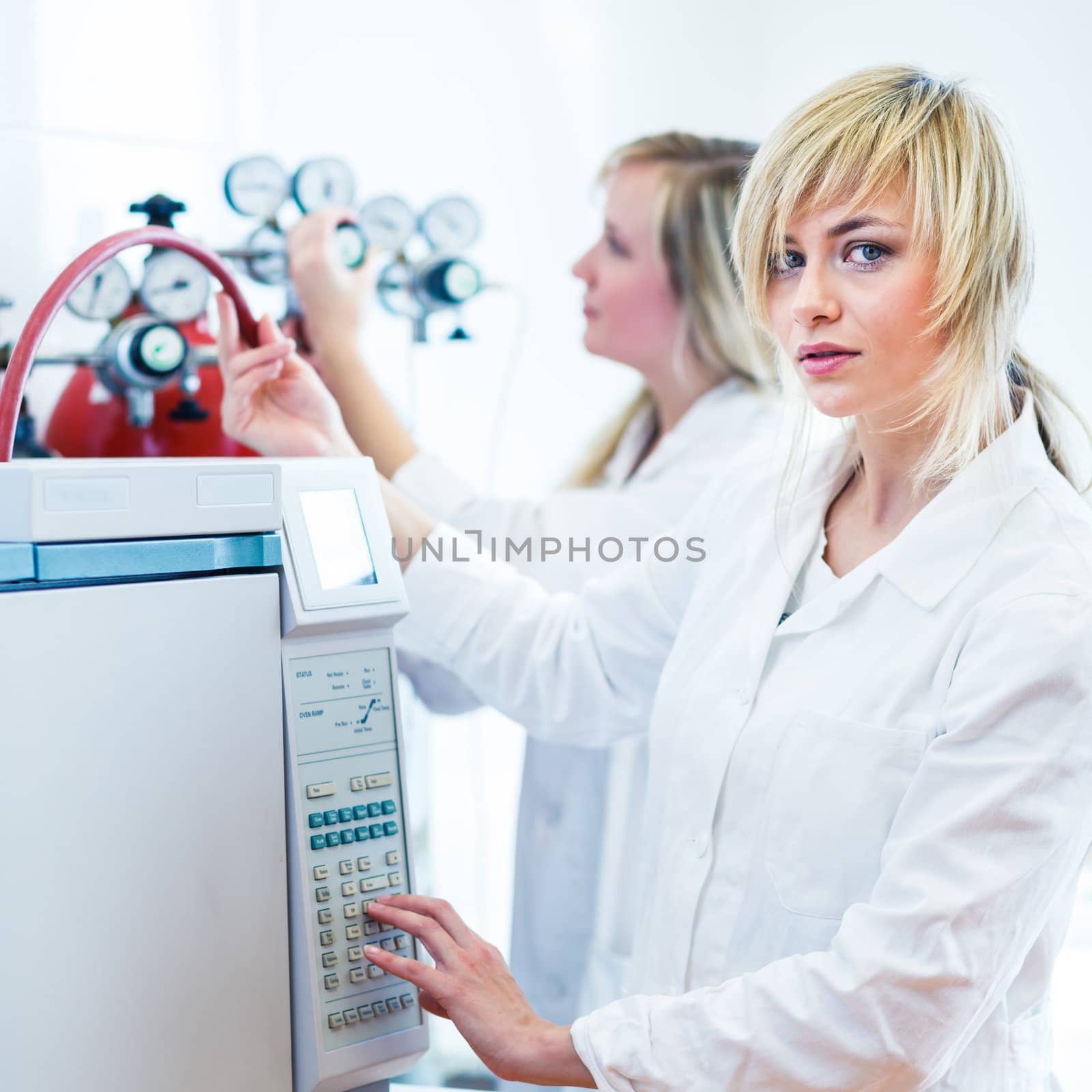 Two female researchers working in a laboratory (color toned image)