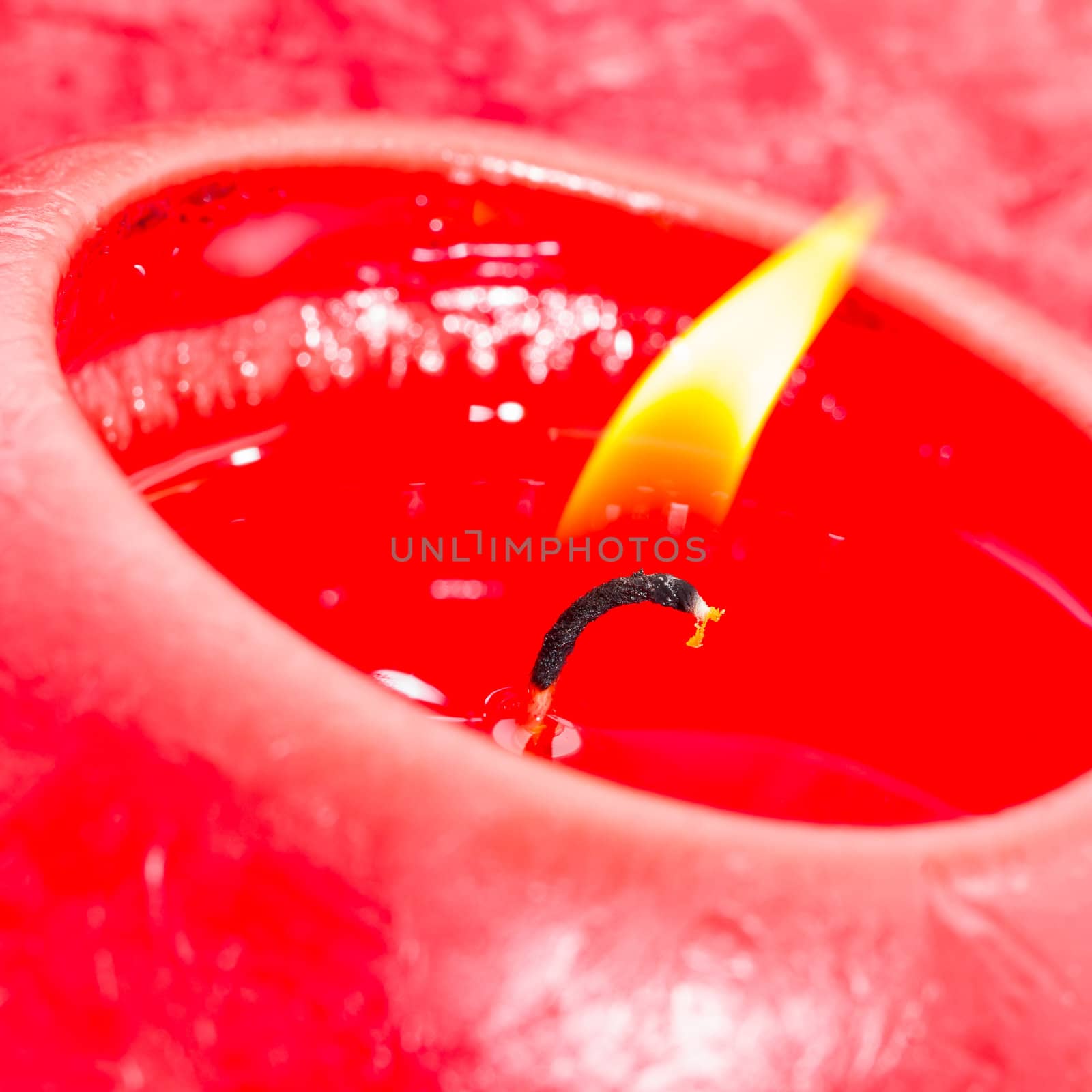 Close-up of a red candle, bright flame