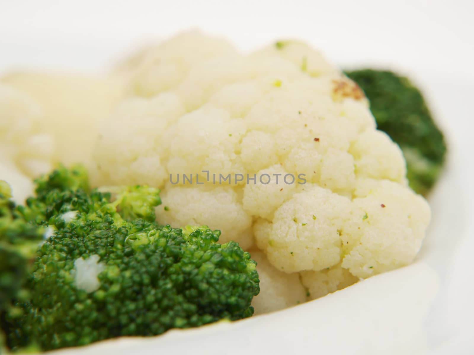 Broccoli and cauliflower isolated on white plate, towards white background by Arvebettum