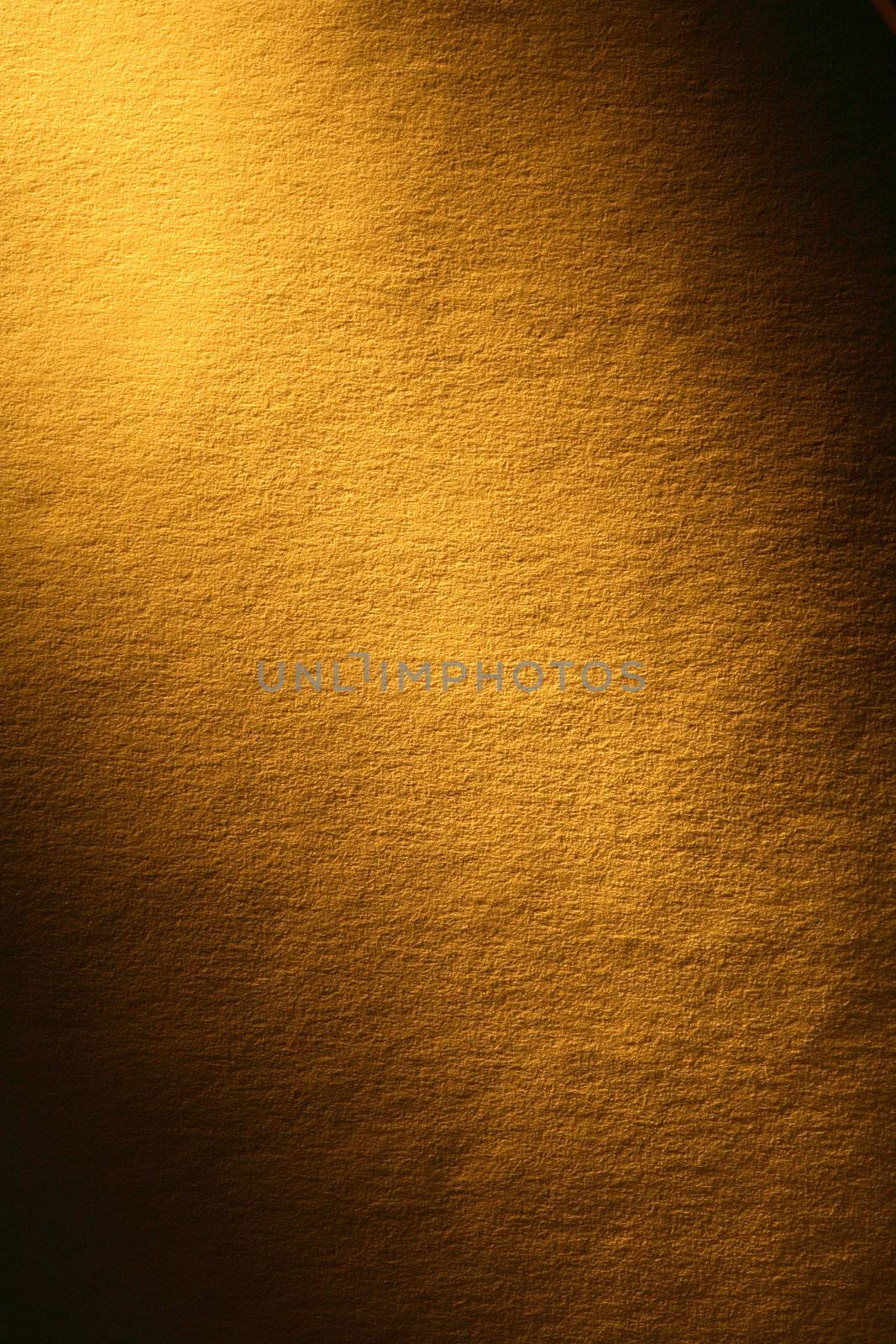 Old yellow paper surface with beam of light. Good background for your text