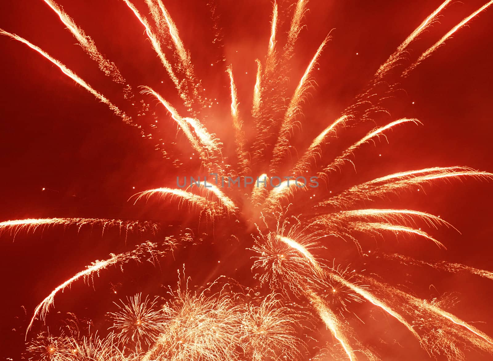 red holiday fireworks in night sky