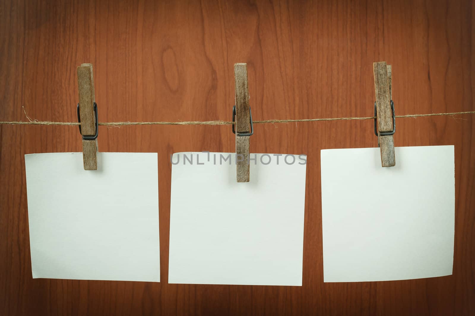 white memory note paper hanging on cord on wooden background
