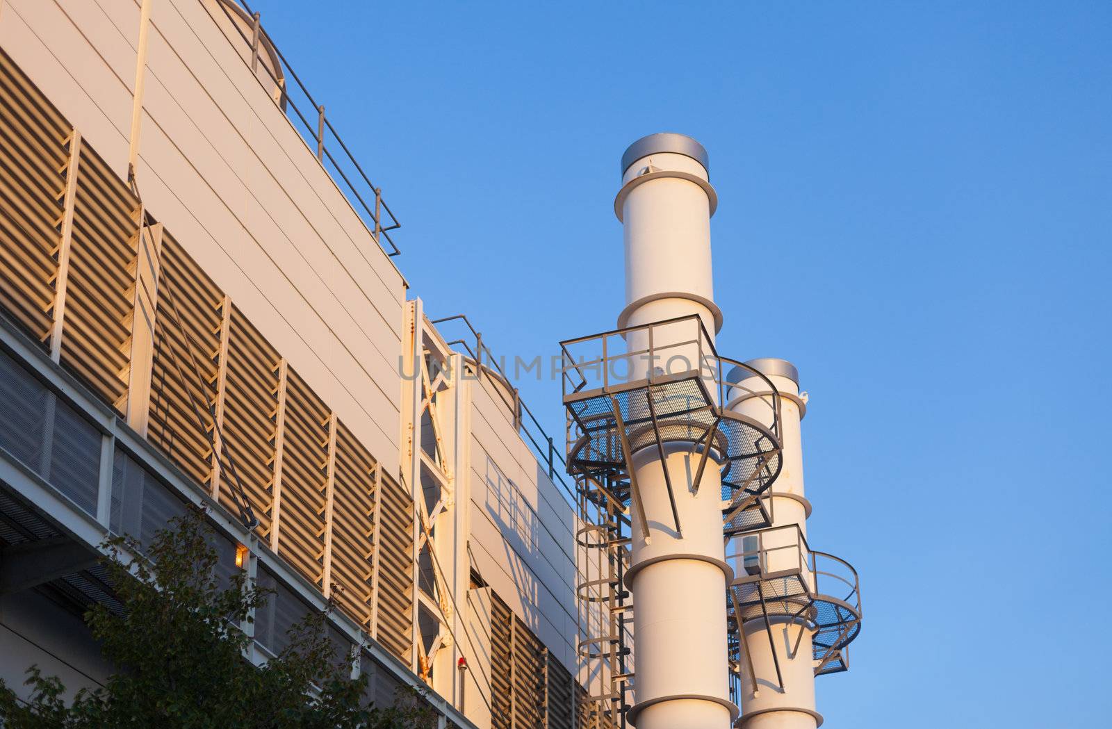 Industiral cooling plant in late afternoon with blue sky
