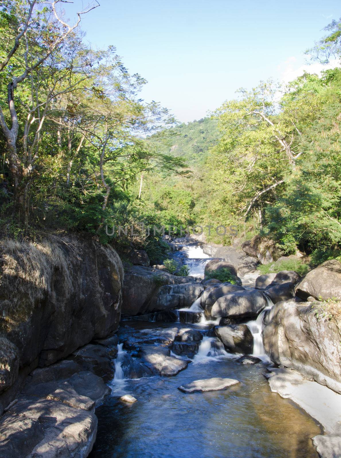 waterfall on mountain river  by siraanamwong