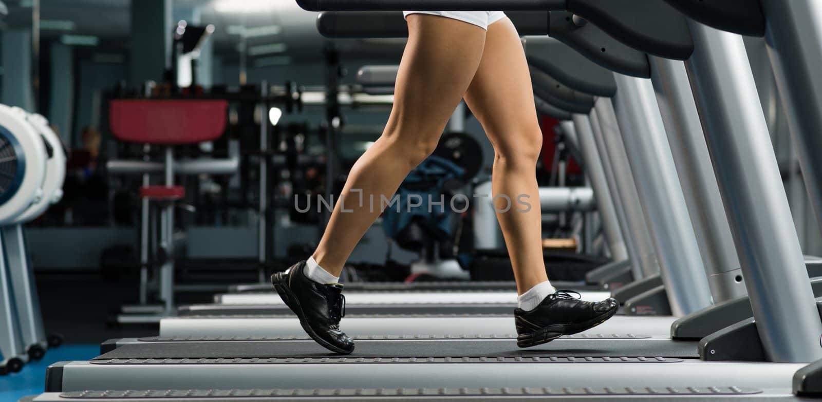 woman running on a treadmill by adam121