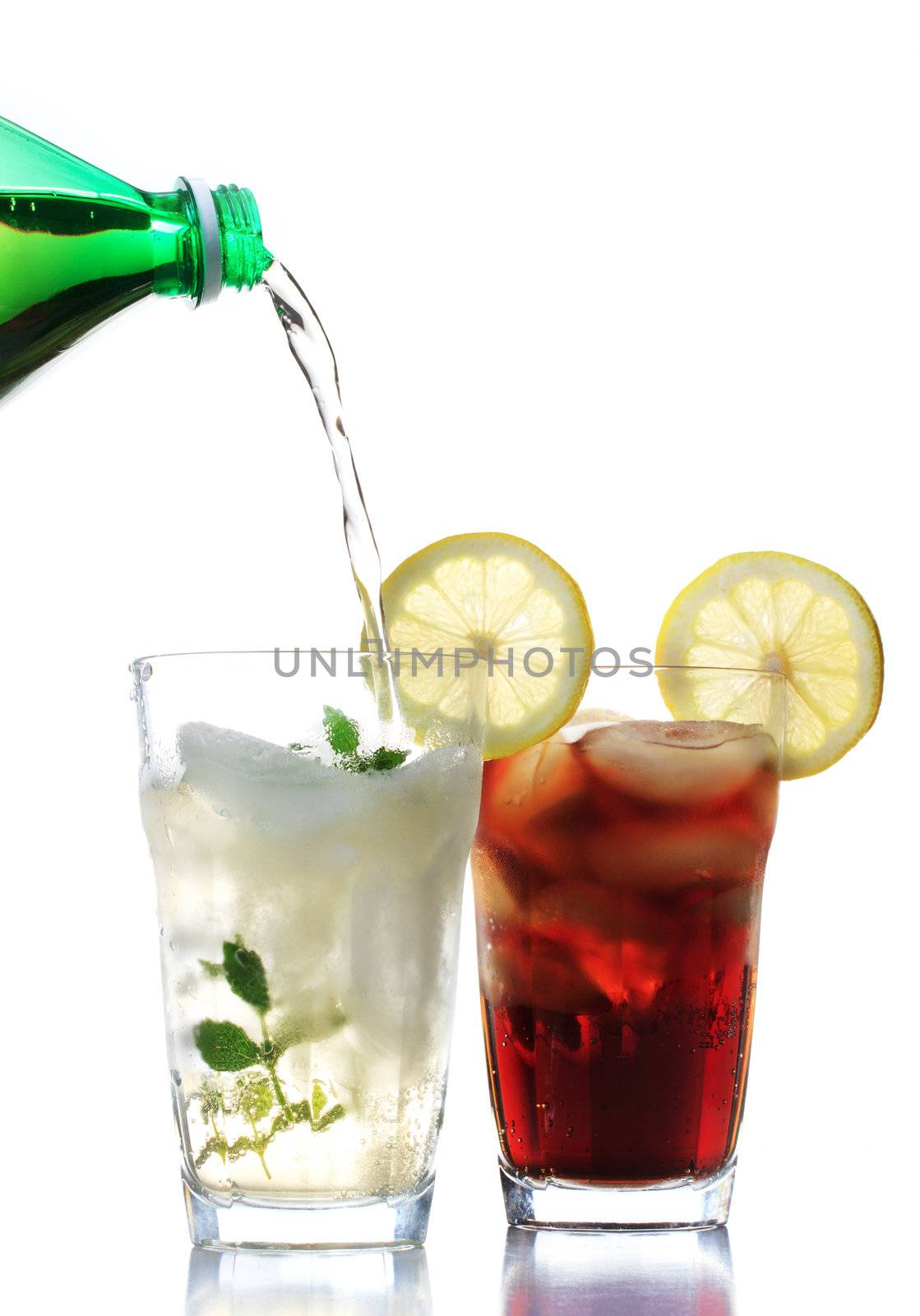 Ginger ale and cola in the glasses with lemon garnish