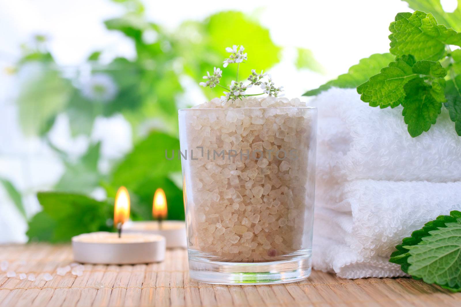 Bath salt with fresh mint leaves and towels