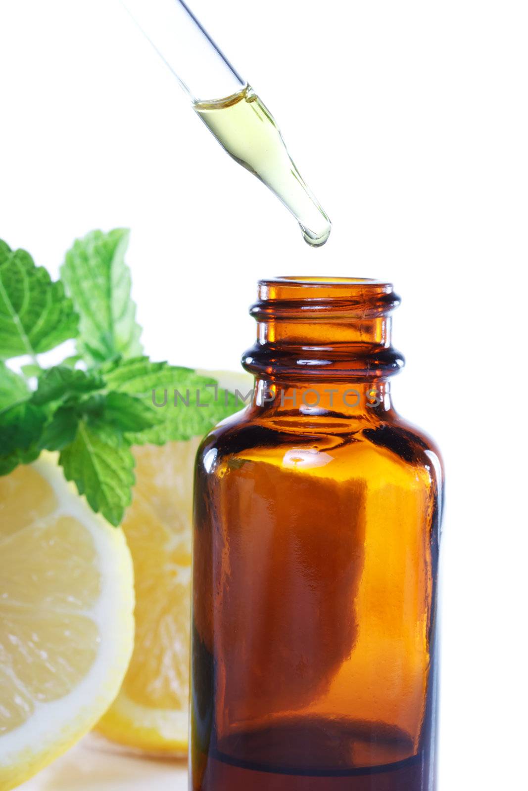 Herbal medicine dropper bottle with mint leaves and lemon