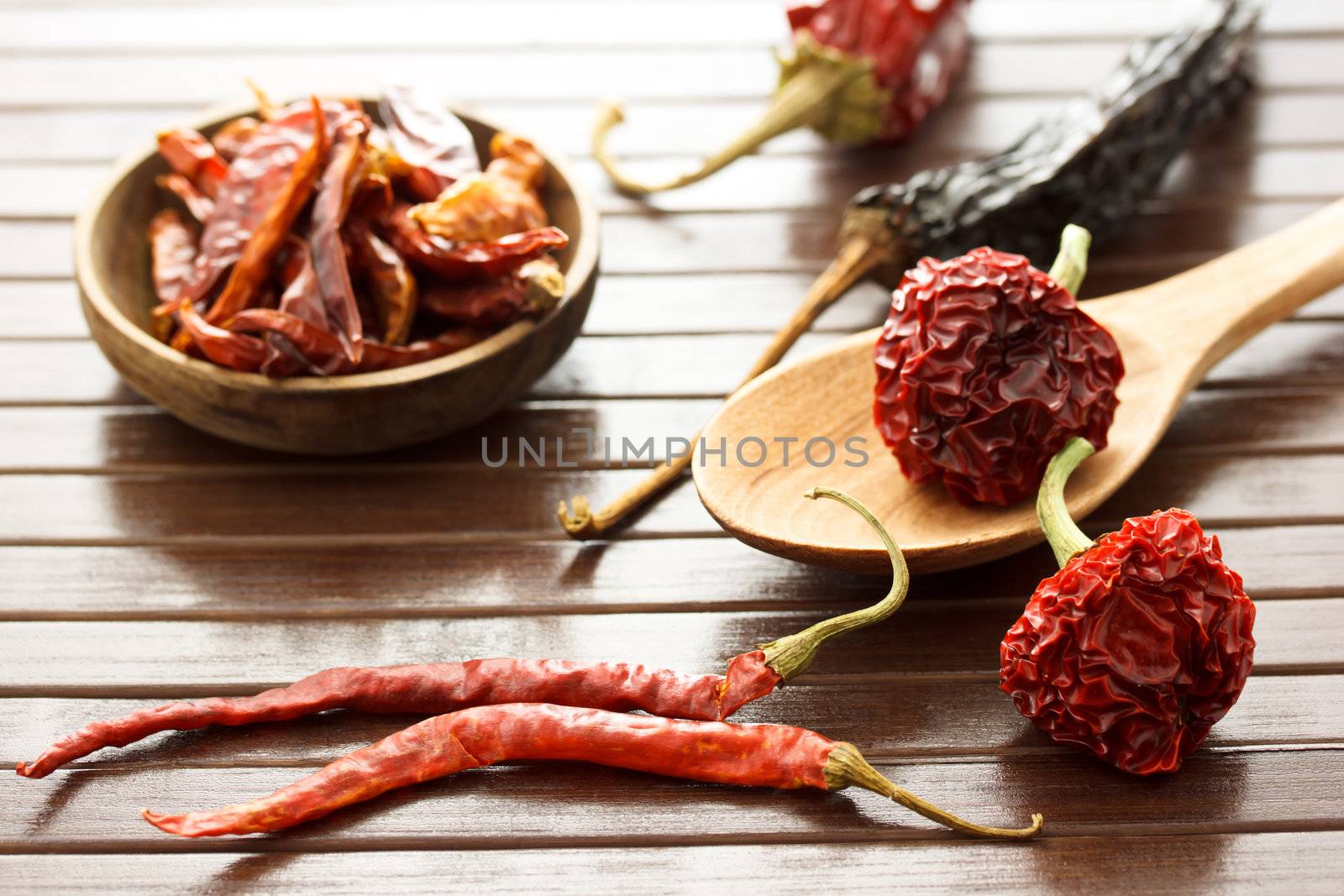 Assortment of dried chili peppers  on wooden matt