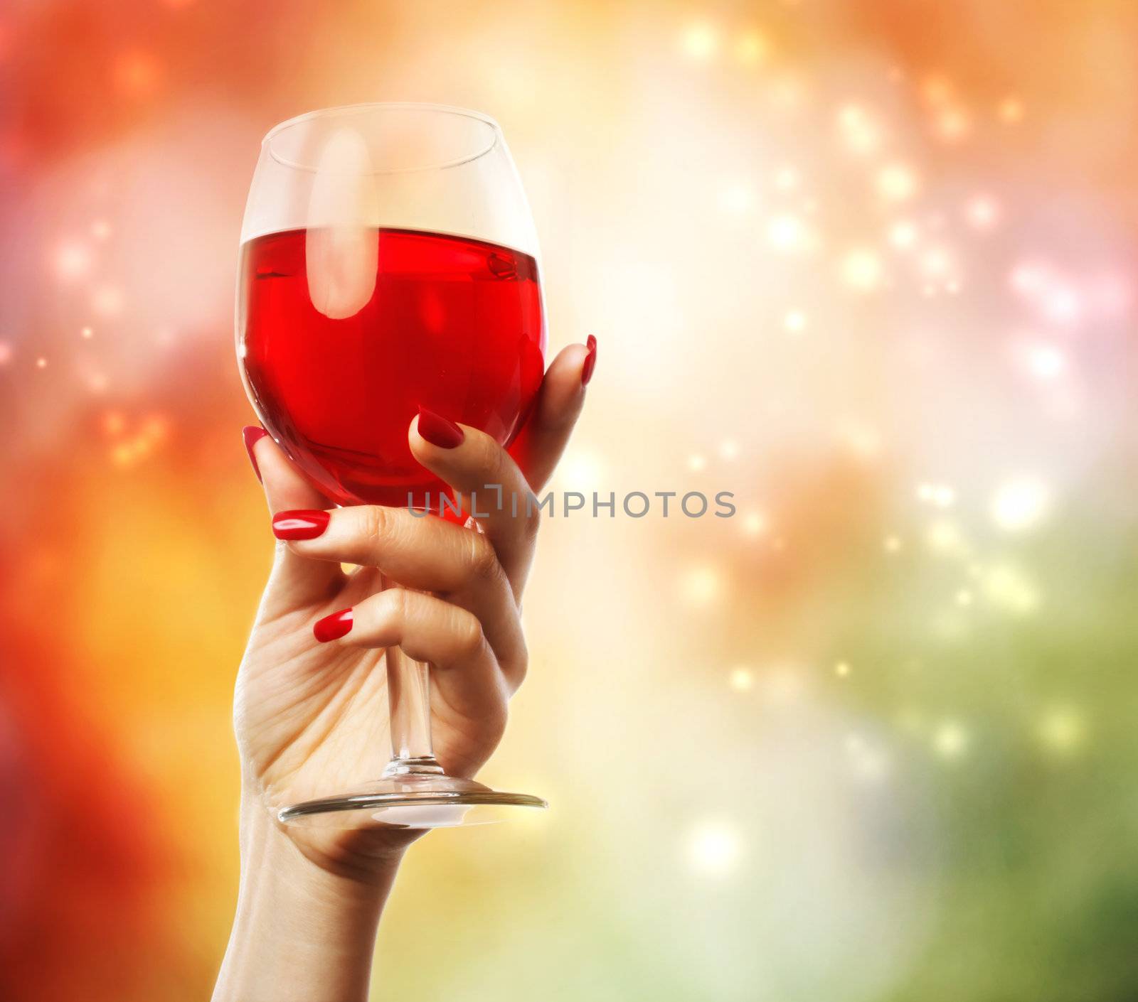 Woman holding a wine glass on abstract light background