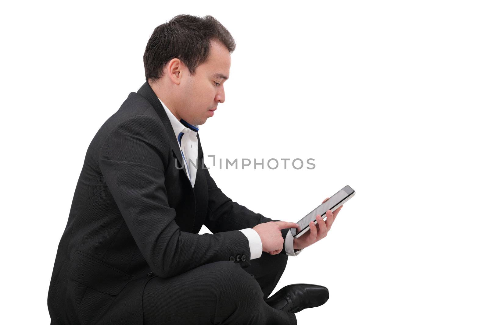 businessman with digital pad touch screen sitting in yoga lotus by dacasdo