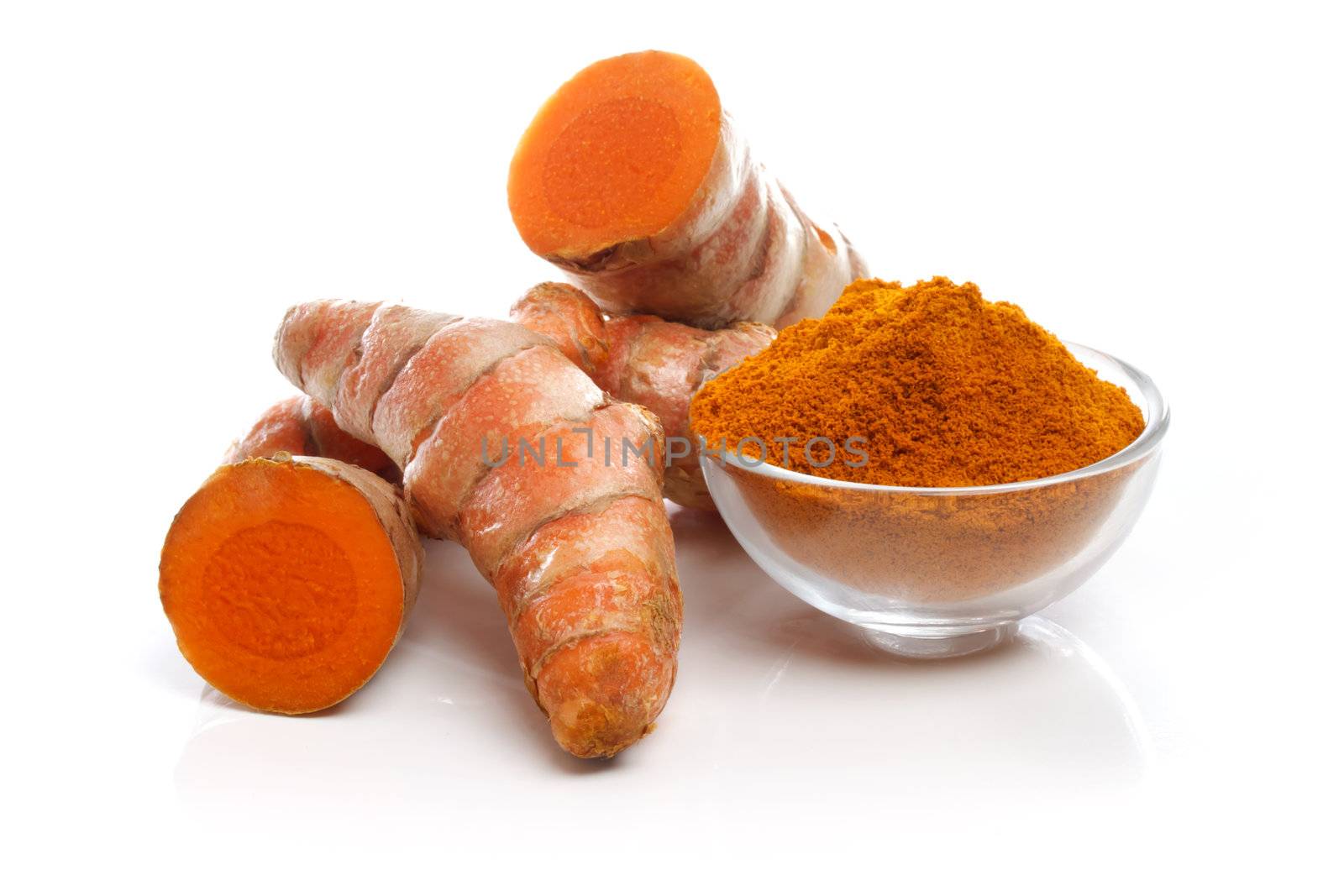 Turmeric roots and powder on white background 