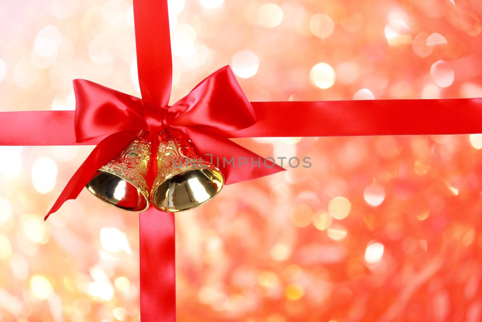 Red Christmas Ribbon with Bells over Christmas Abstract Lights