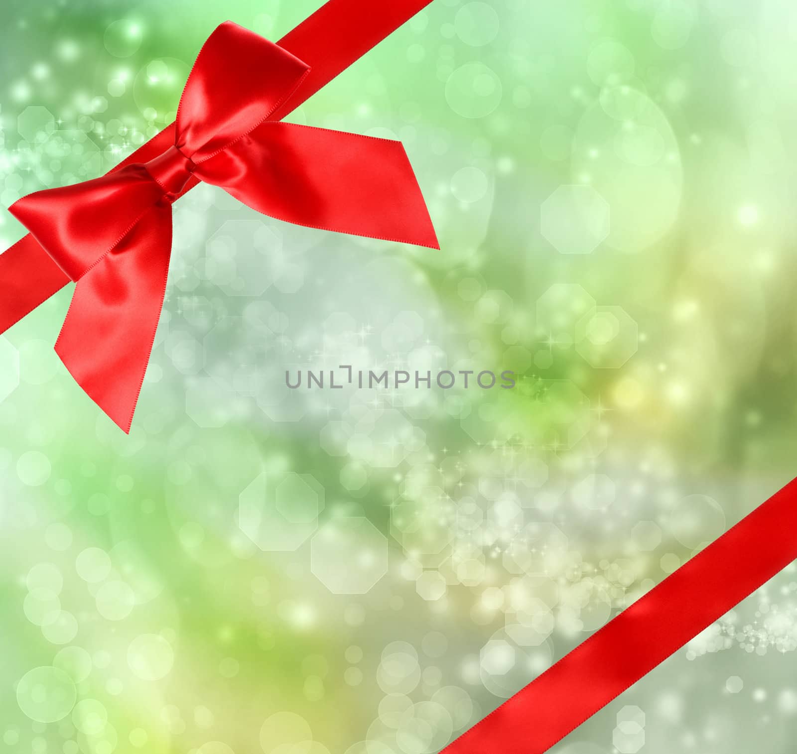 Red Bow and Ribbon with Green Bokeh Lights Background 