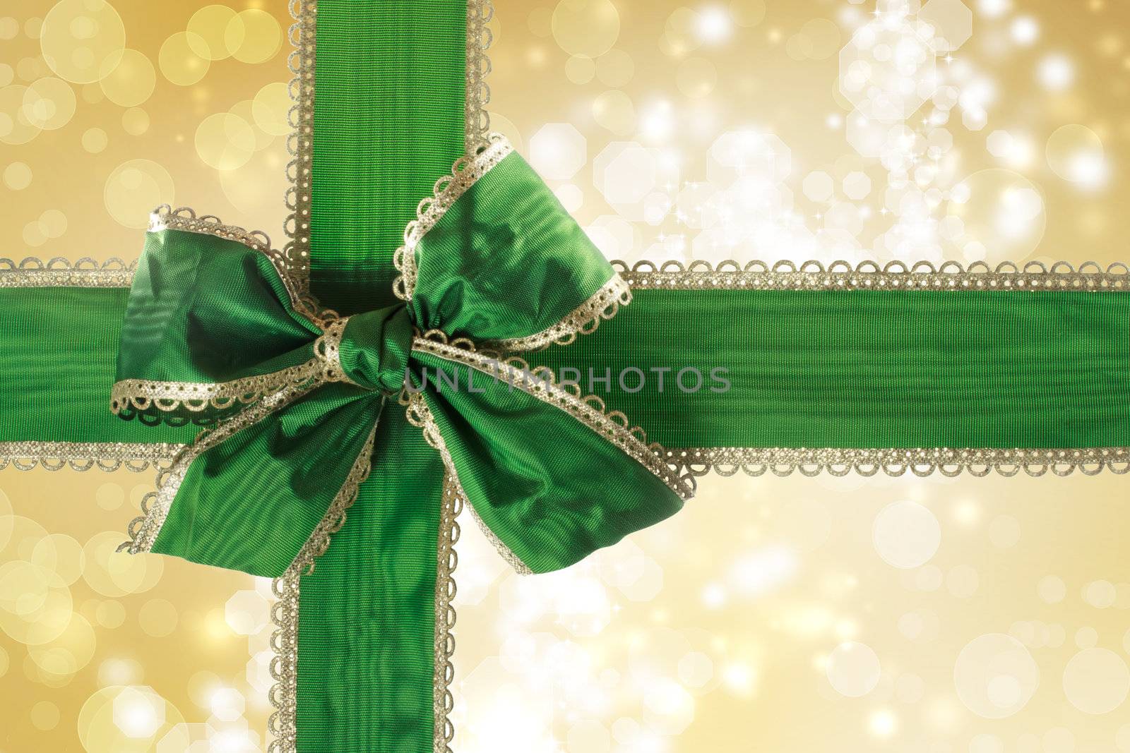 Green Bow and Ribbon with Gold Bokeh Lights Background 