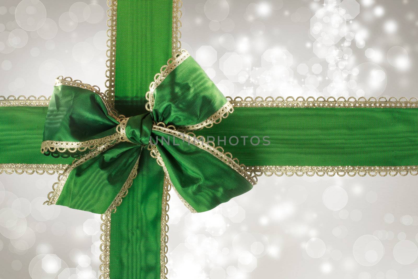 Green Bow and Ribbon with Silver Bokeh Lights Background 