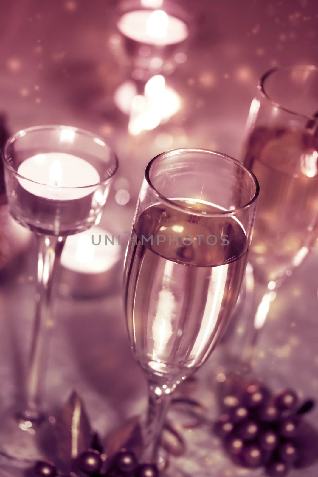 Sparkling champagne glasses with candles 