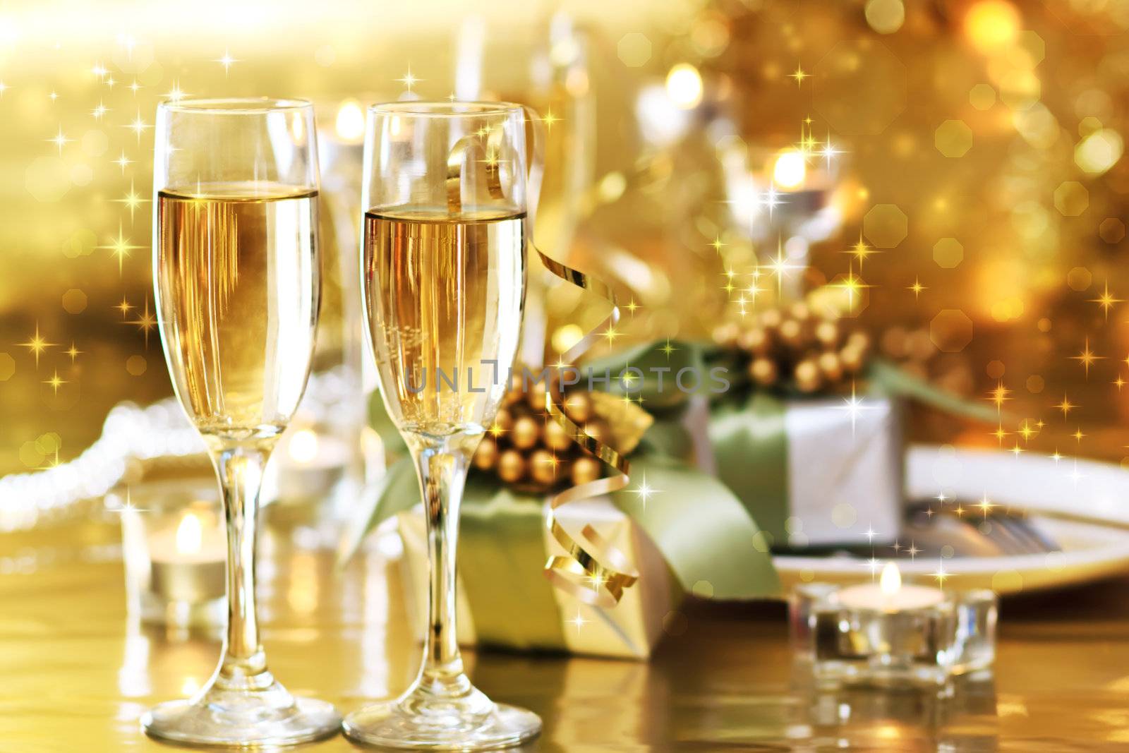 Two champagne glasses on the dinner table with gift boxes