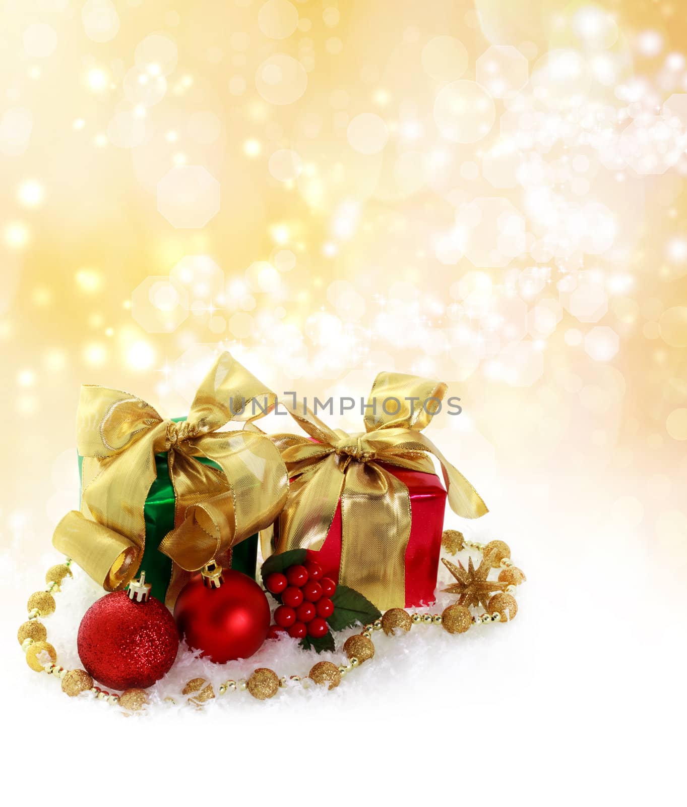 Red and green Christmas gifts over golden lights background