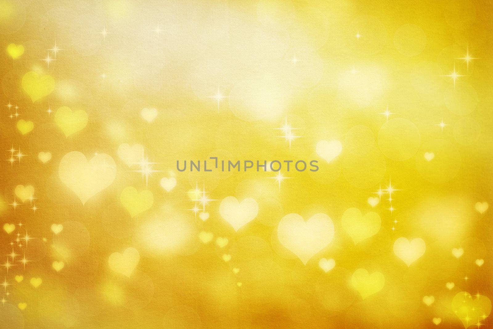 Golden shiny hearts on fabric texture background 