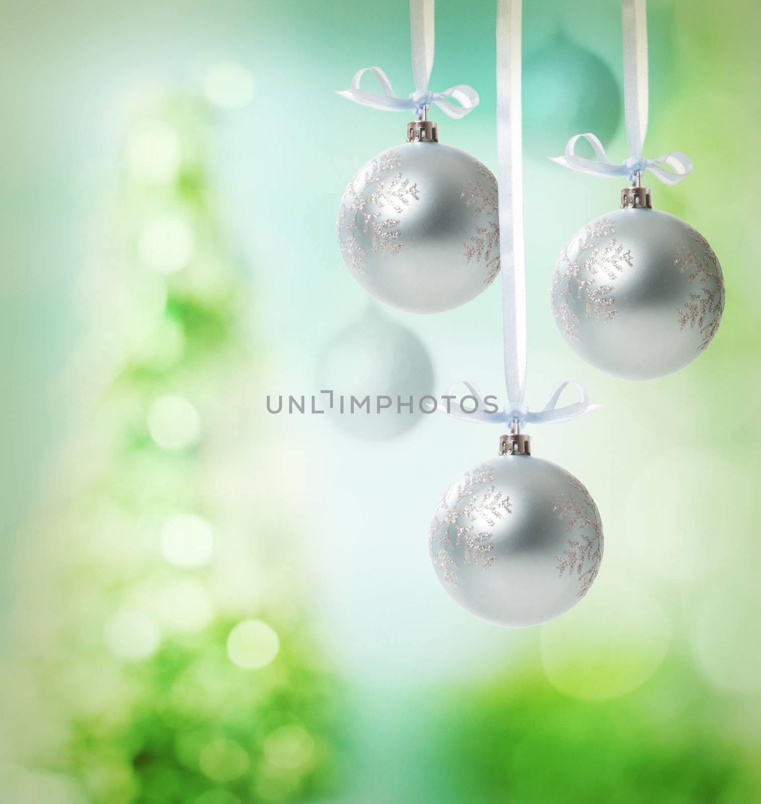 Christmas snowflake ornaments over green tree lights background