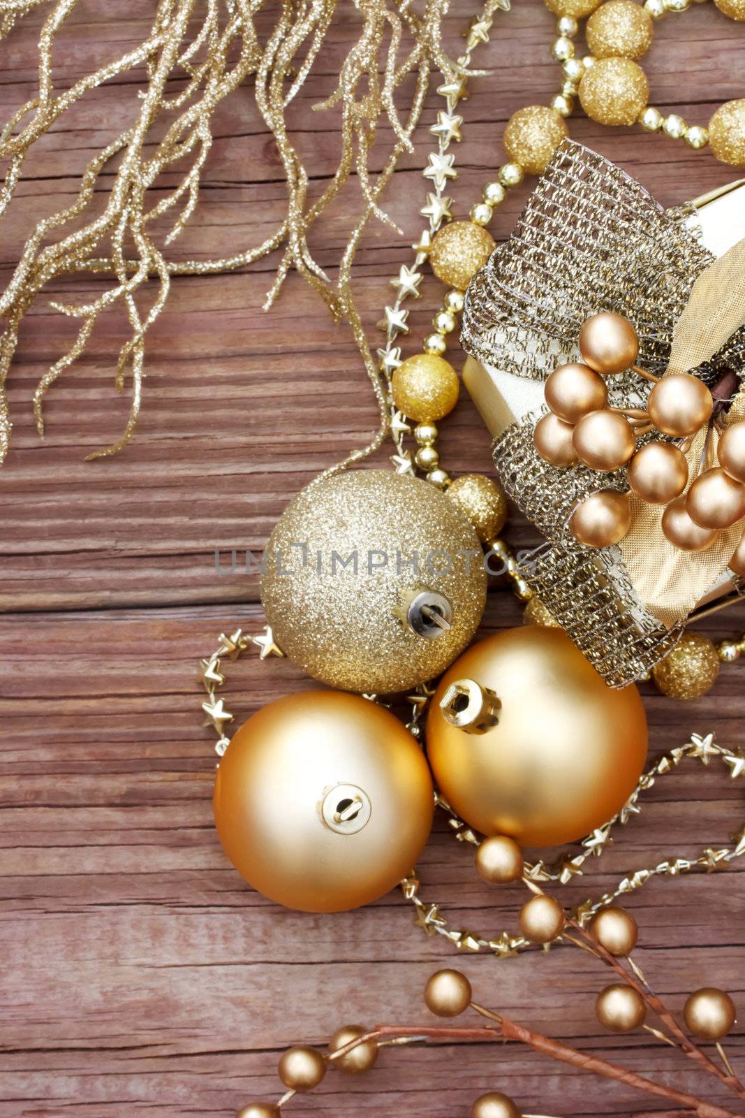 Gold Christmas ornaments on wood 