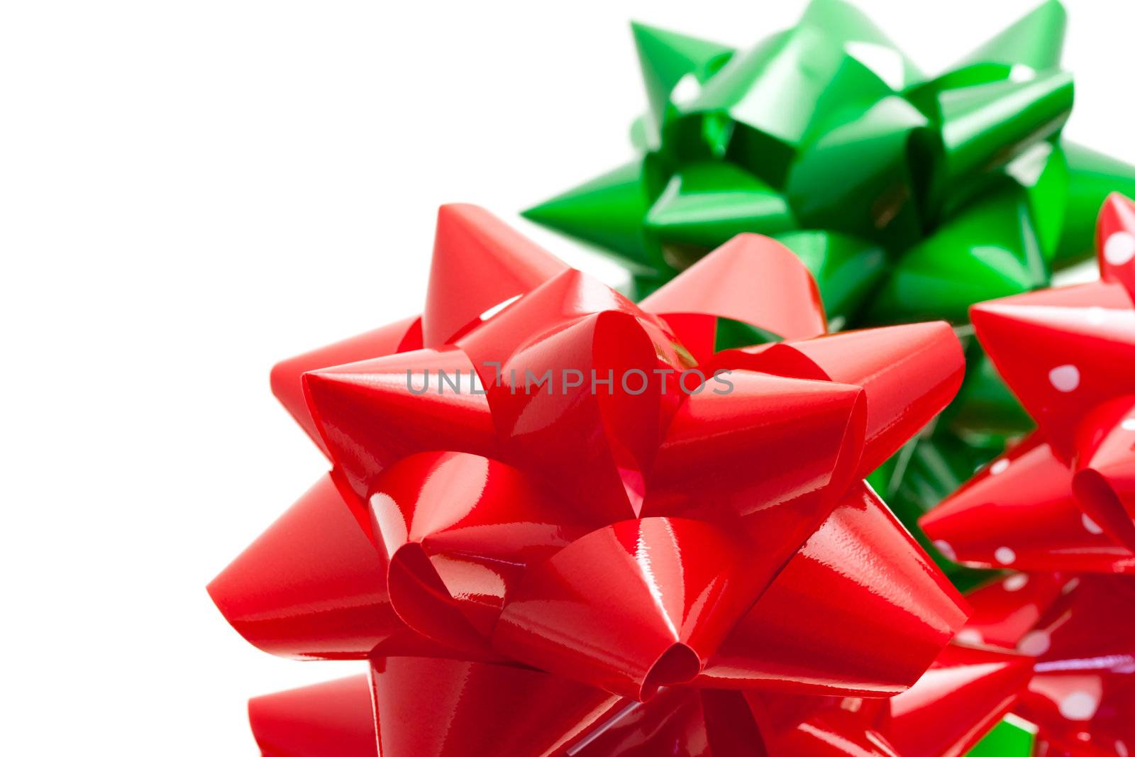 Red and green gift bows isolated on white background