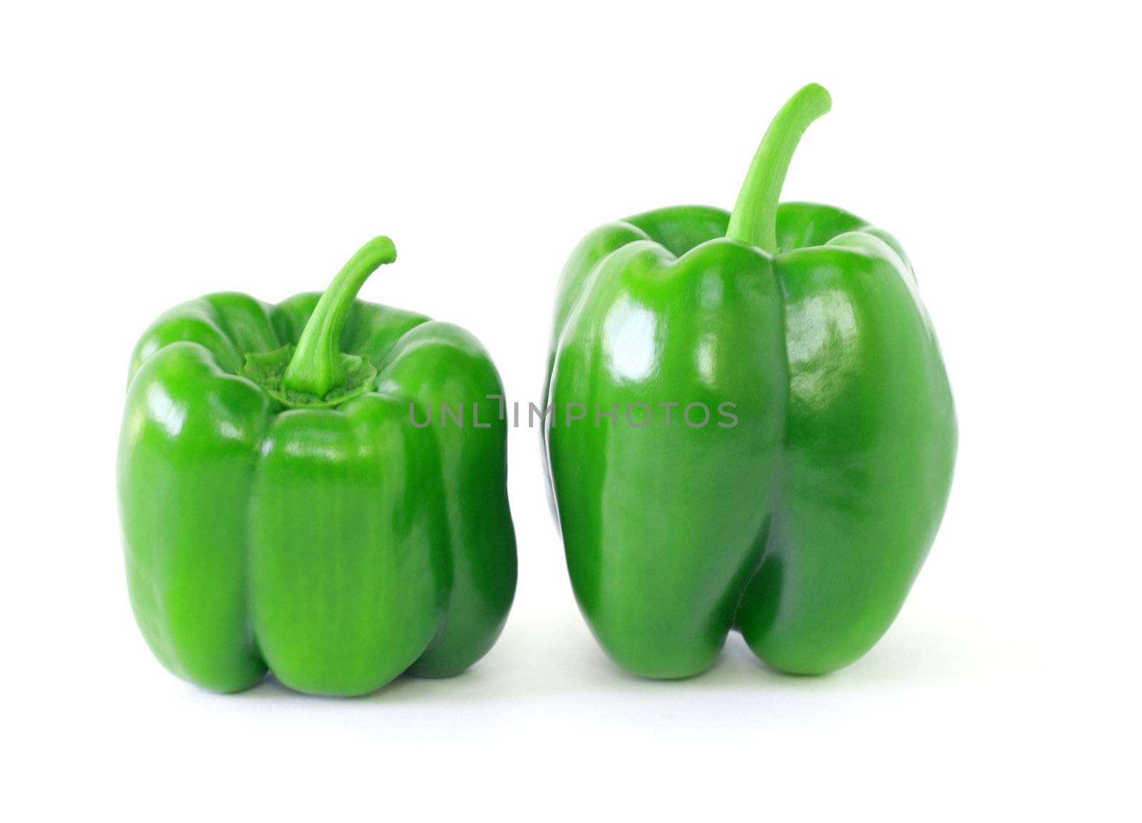 Two green bell peppers isolated on white background