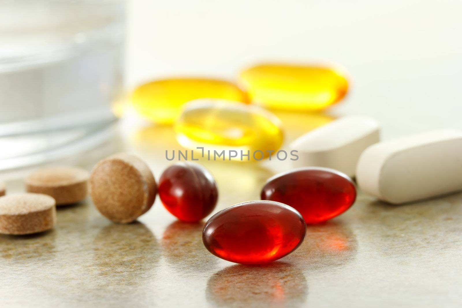 Supplement capsules and glass of water