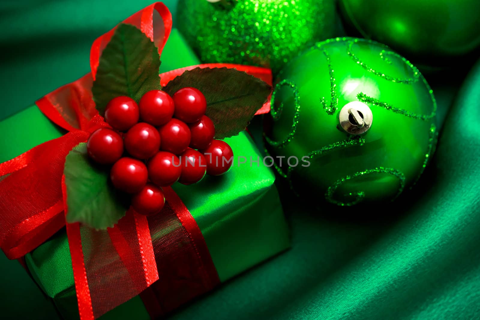 Christmas green gift box with ornaments on silky  cloth
