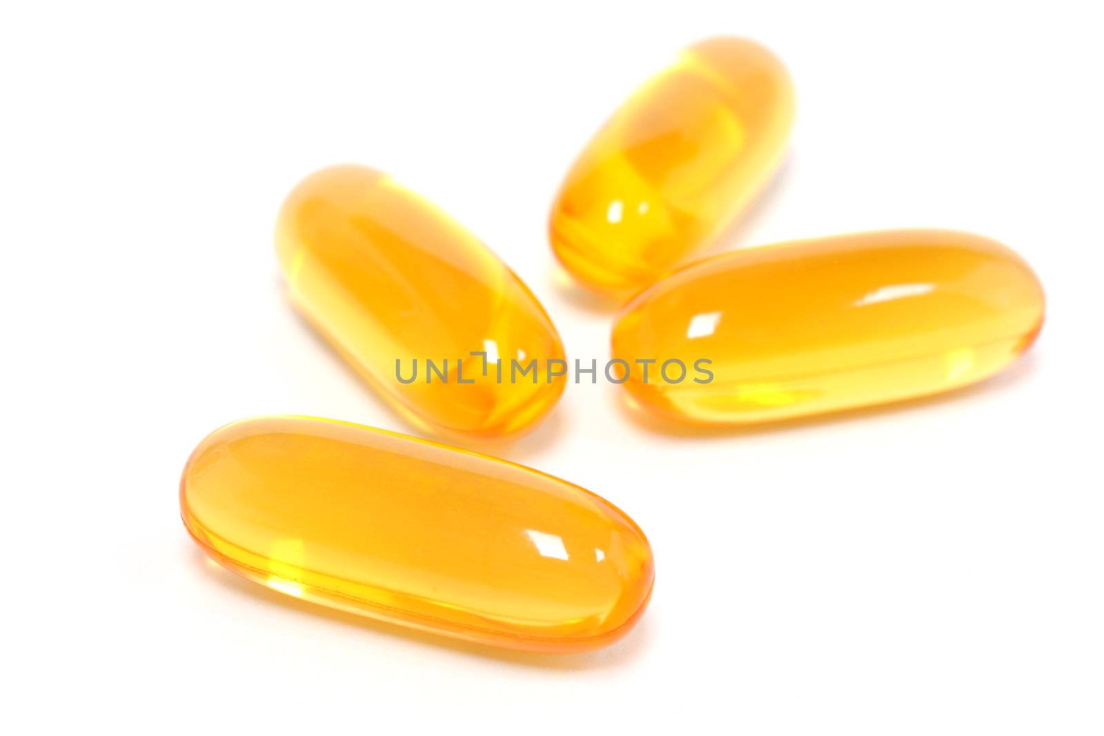 Yellow gel capsules isolated on white background