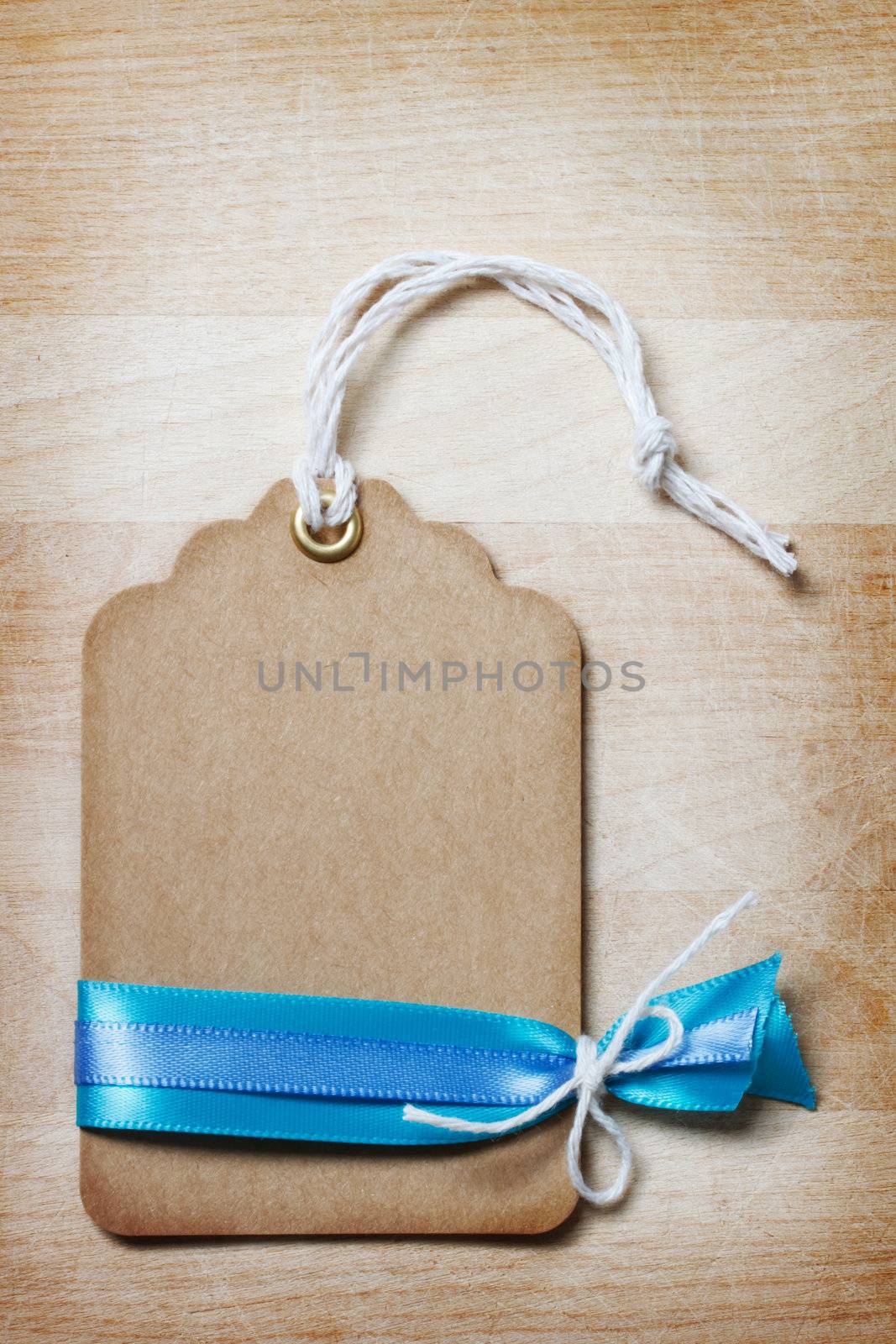 Handmade Price Tag with Ribbon and Decoration on Vintage Wooden Board