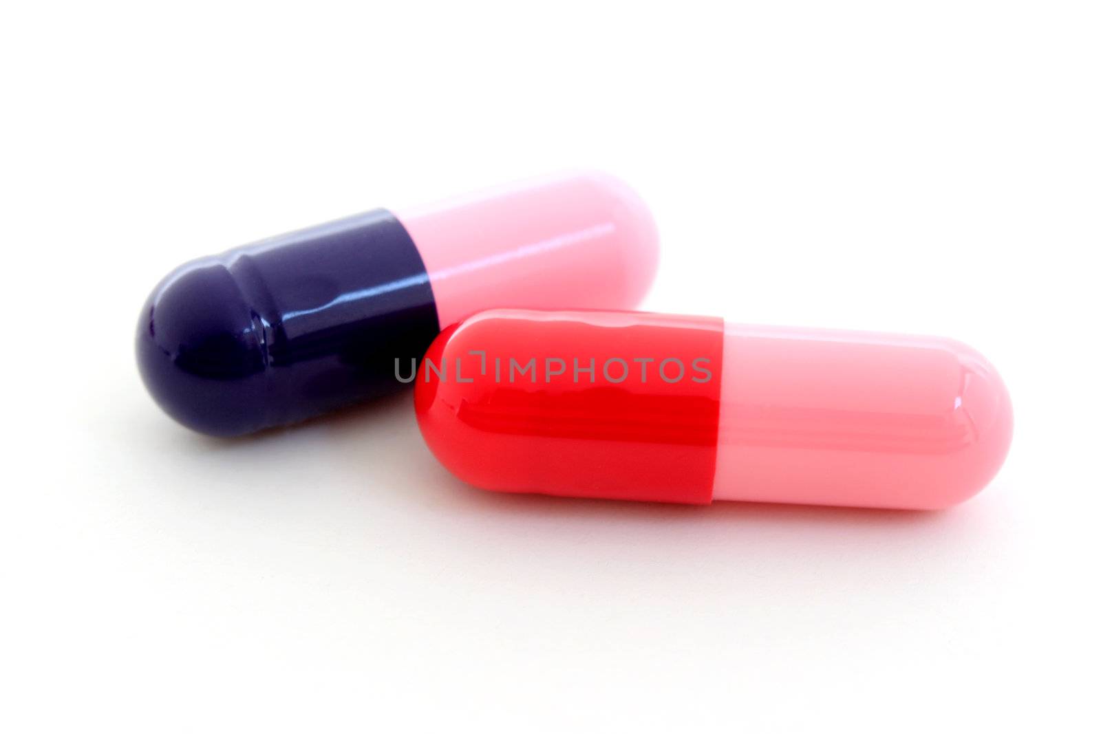 Blue and red capsules isolated on white background