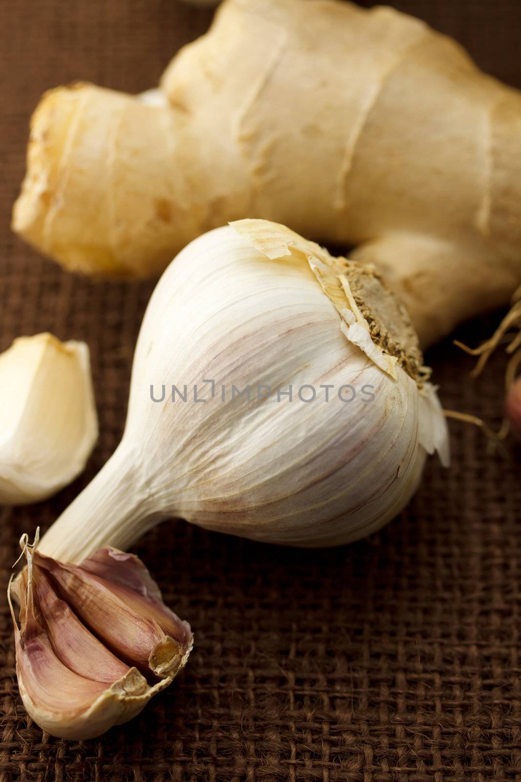 Garlic and ginger on brown cloth