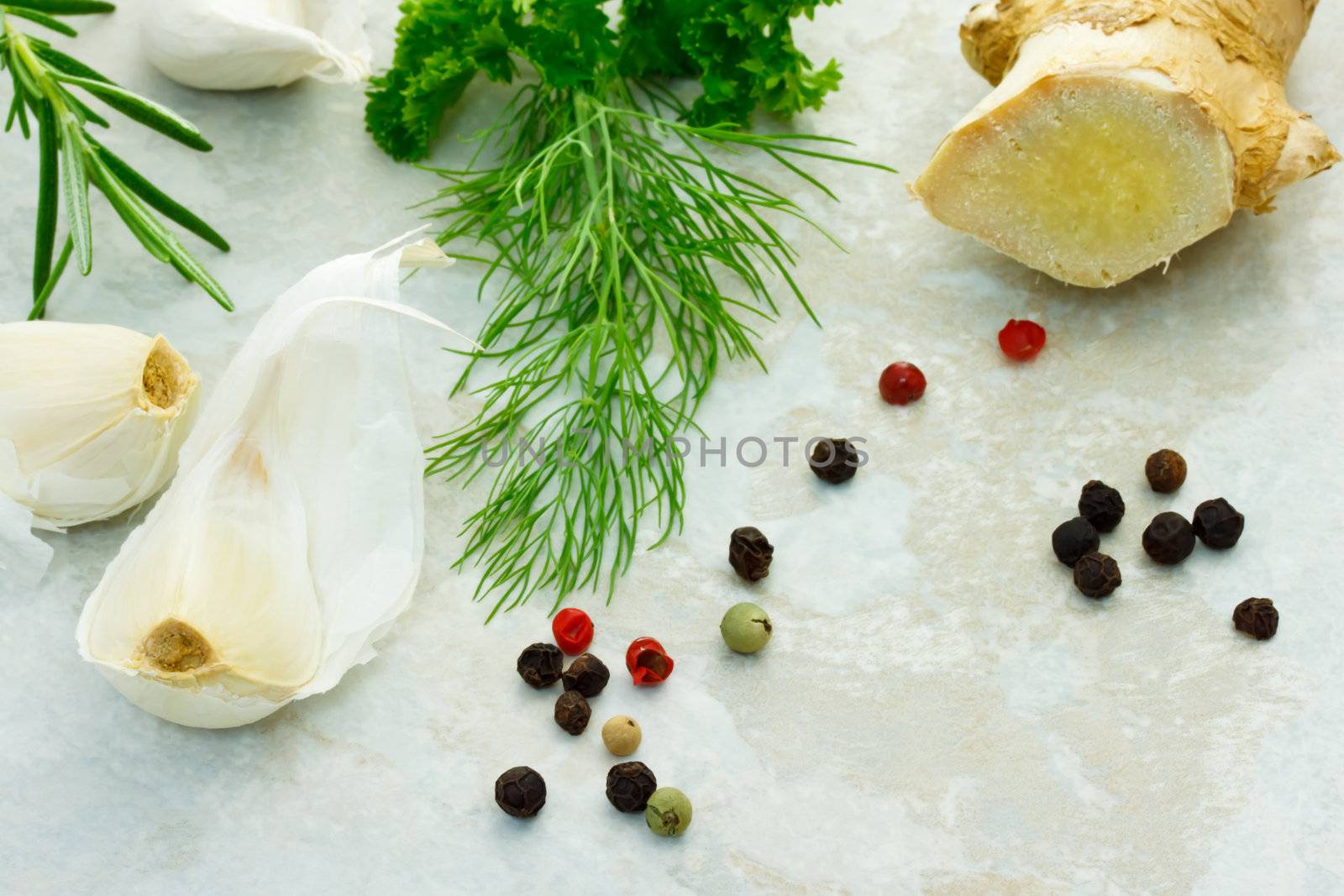 Collection of herbs with ginger, garlic and peppercorn