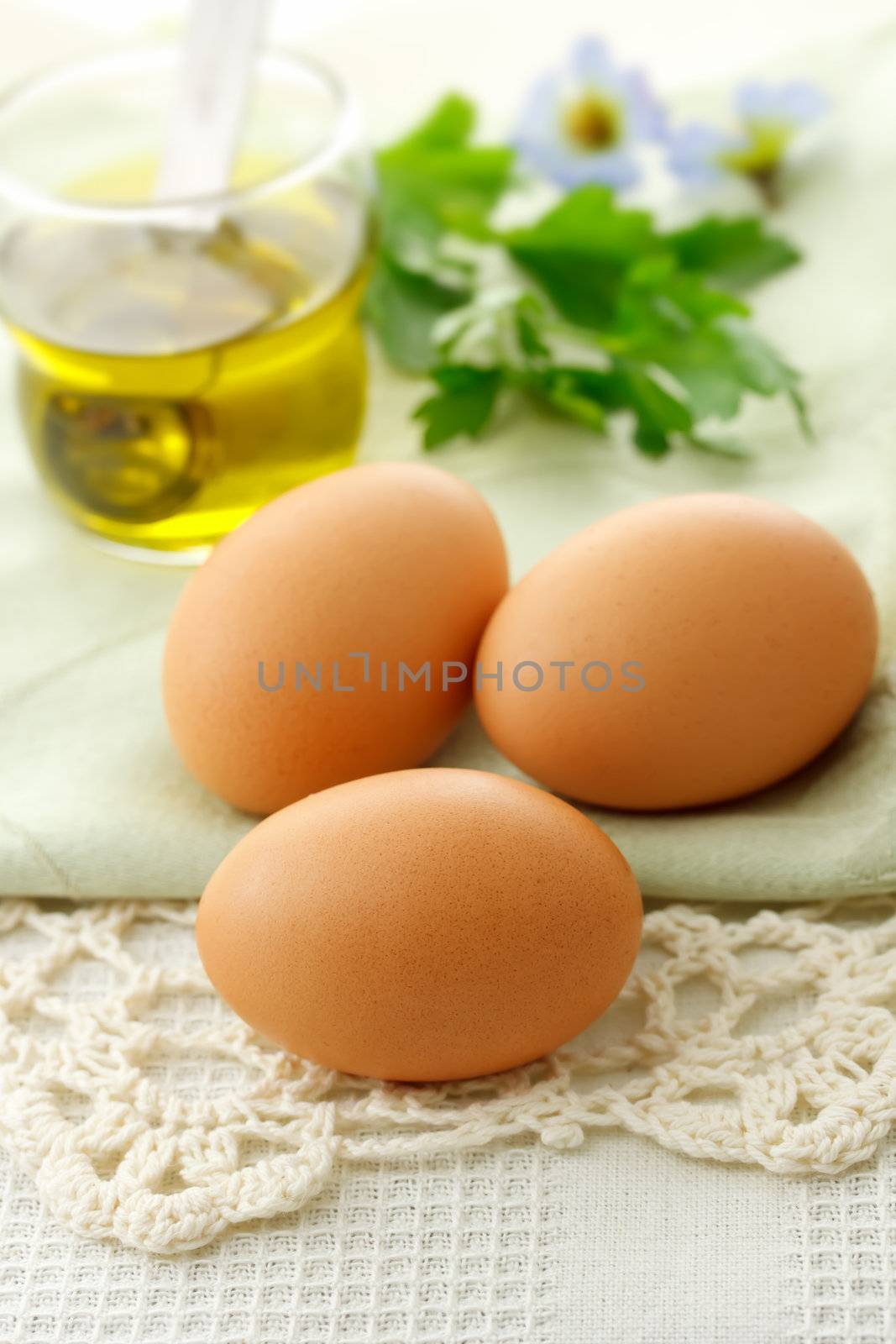 Fresh eggs with olive oil on the table