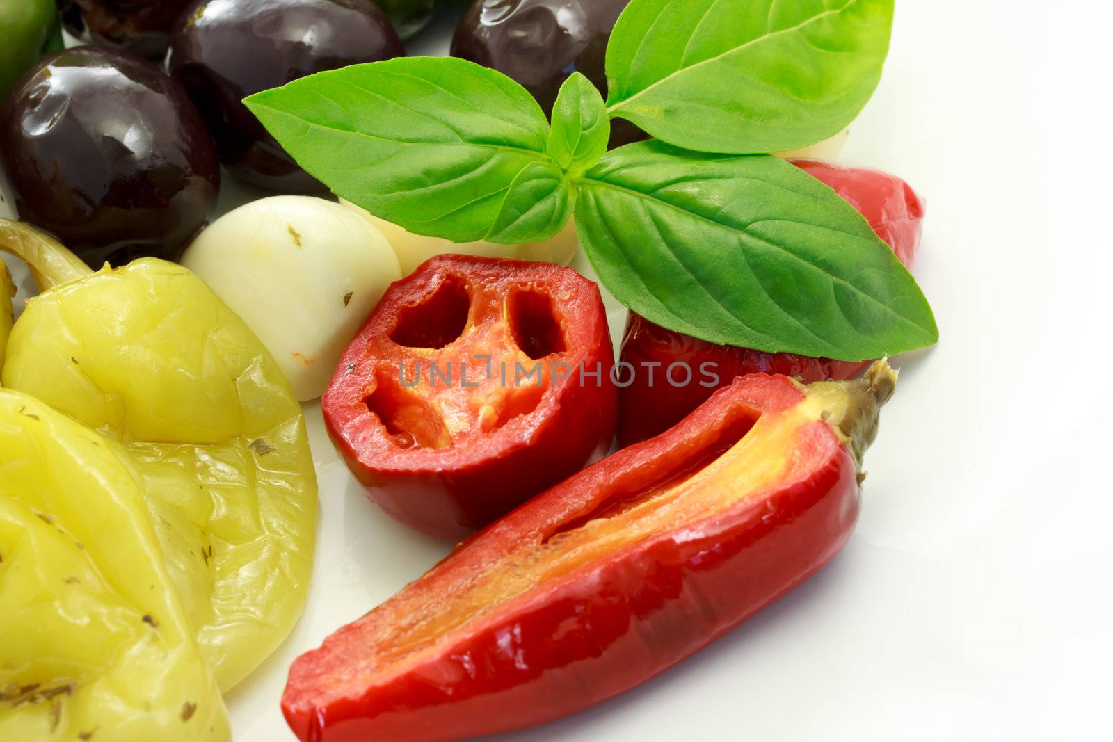 Pickled peppers and olives on white dish