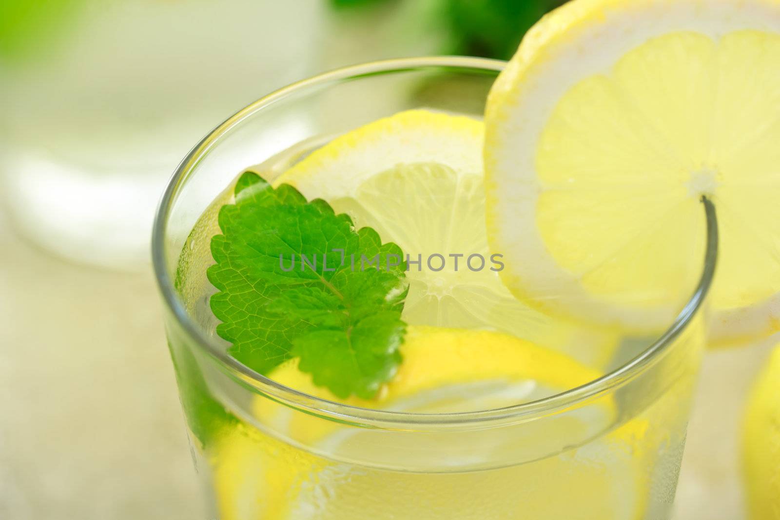 glass of lemonade with lemon and mint