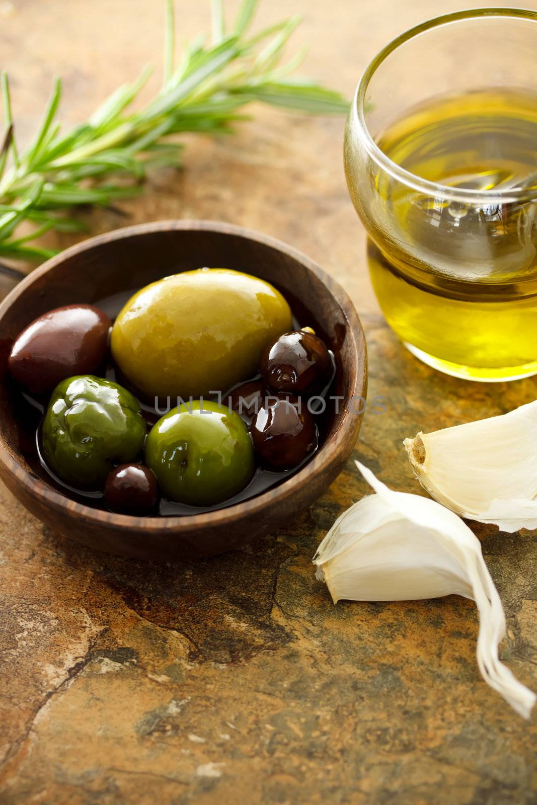 Olive oil and mixed olives with garlic cloves