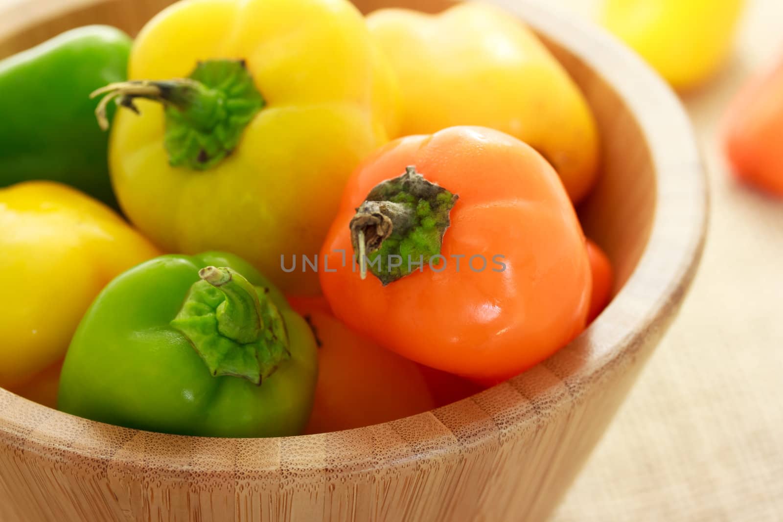 Small sweet peppers in wooden bowl