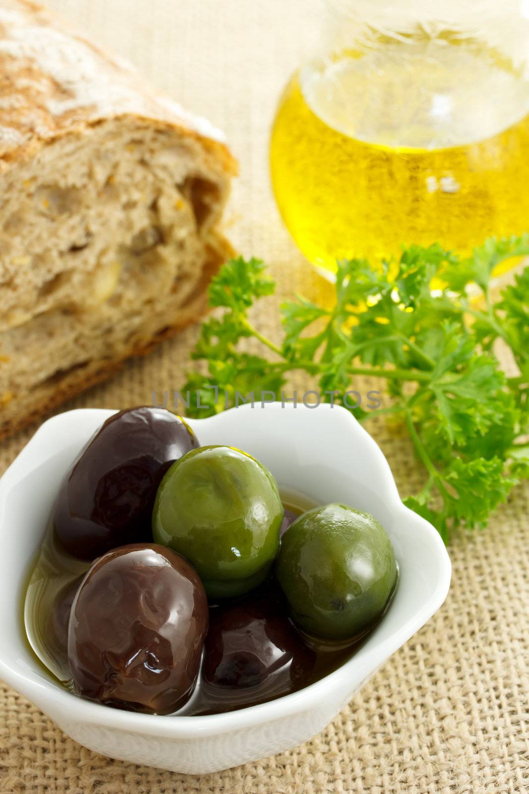 Mixed olives with bread, olive oil and parsley