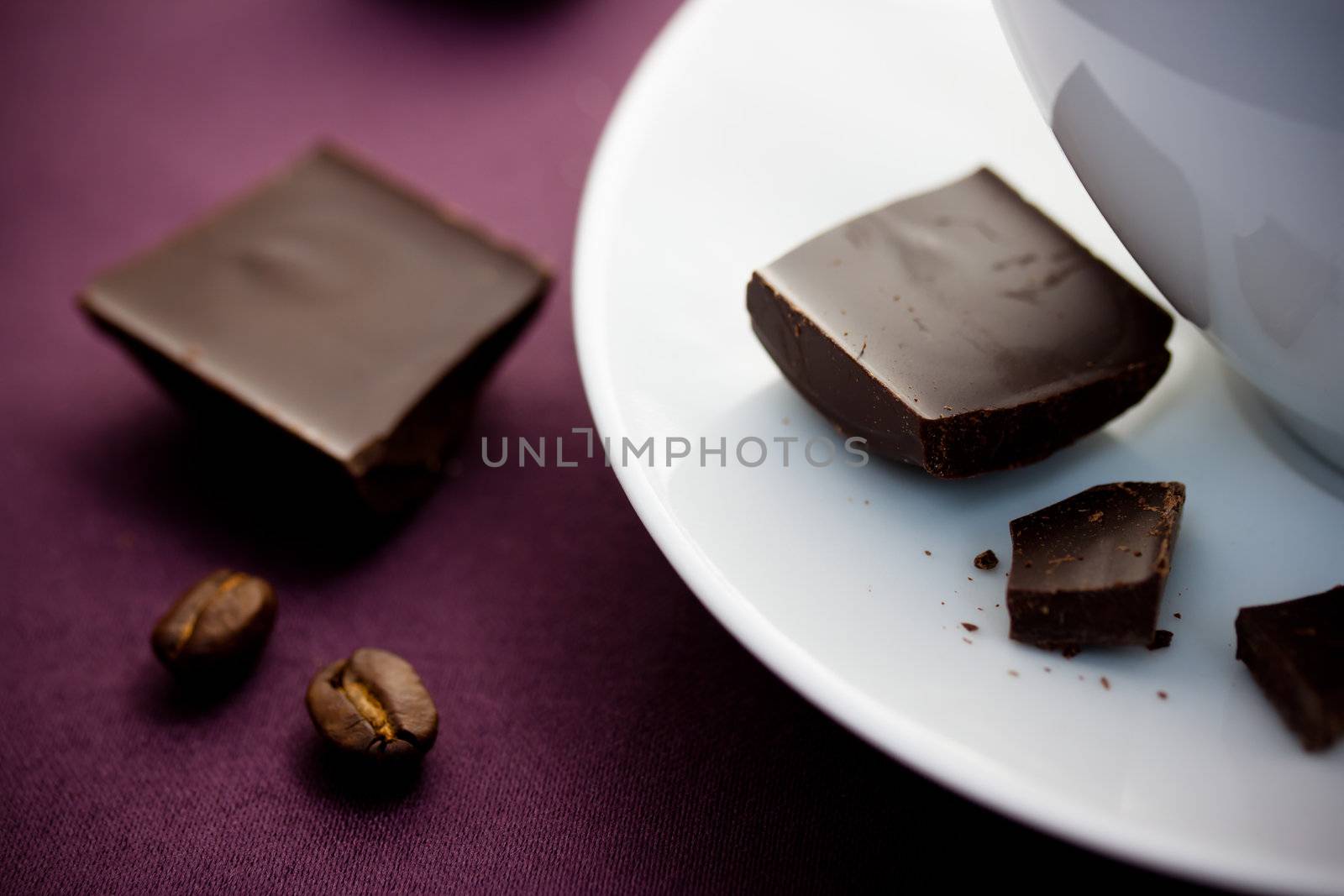 Chocolate with coffee cup on violet tablecloth