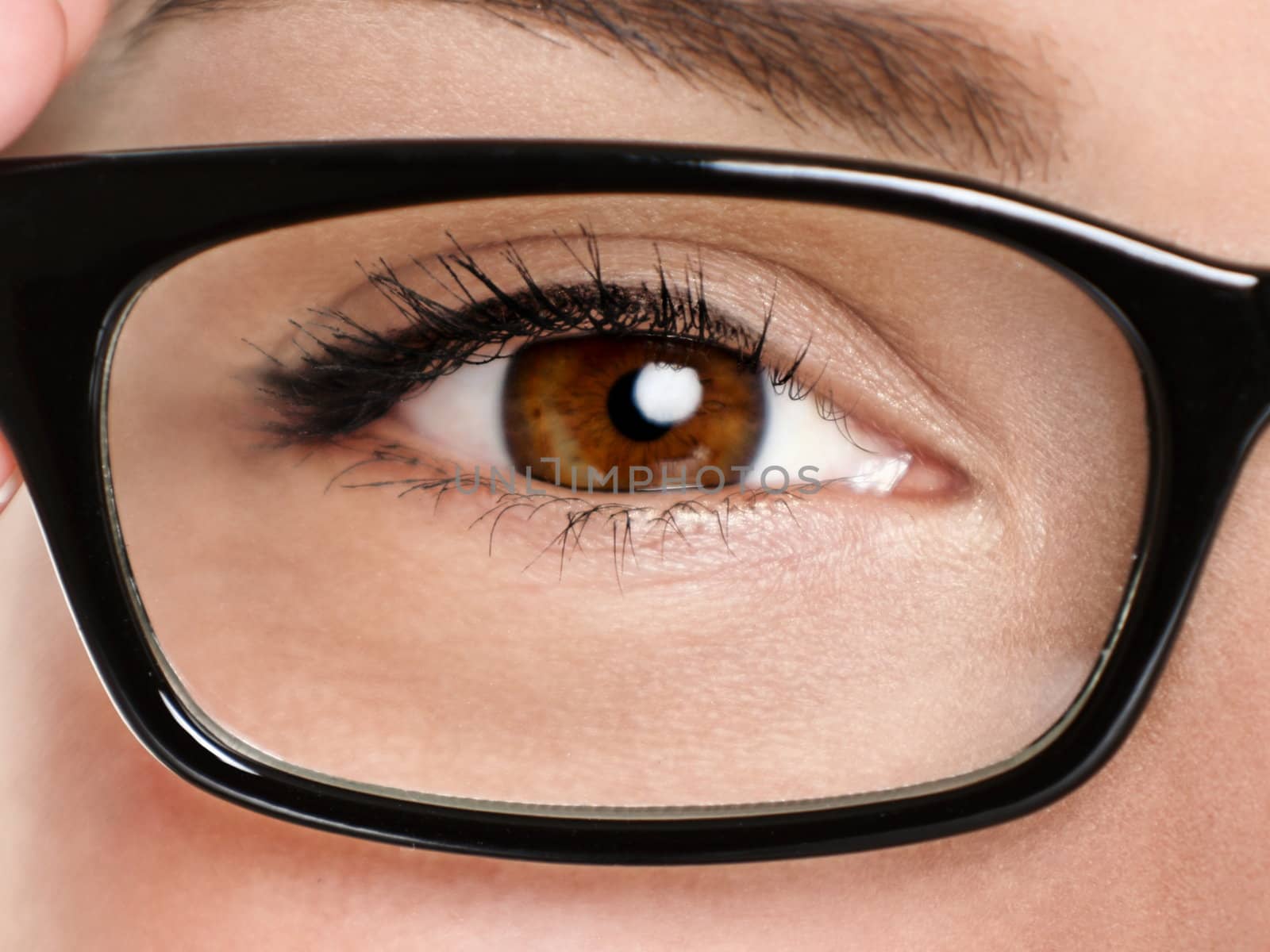 Glasses eyewear closeup. Macro of woman black eye wear glasses frame. Brown eyes of multiethnic Chinese Asian / Caucasian woman model.