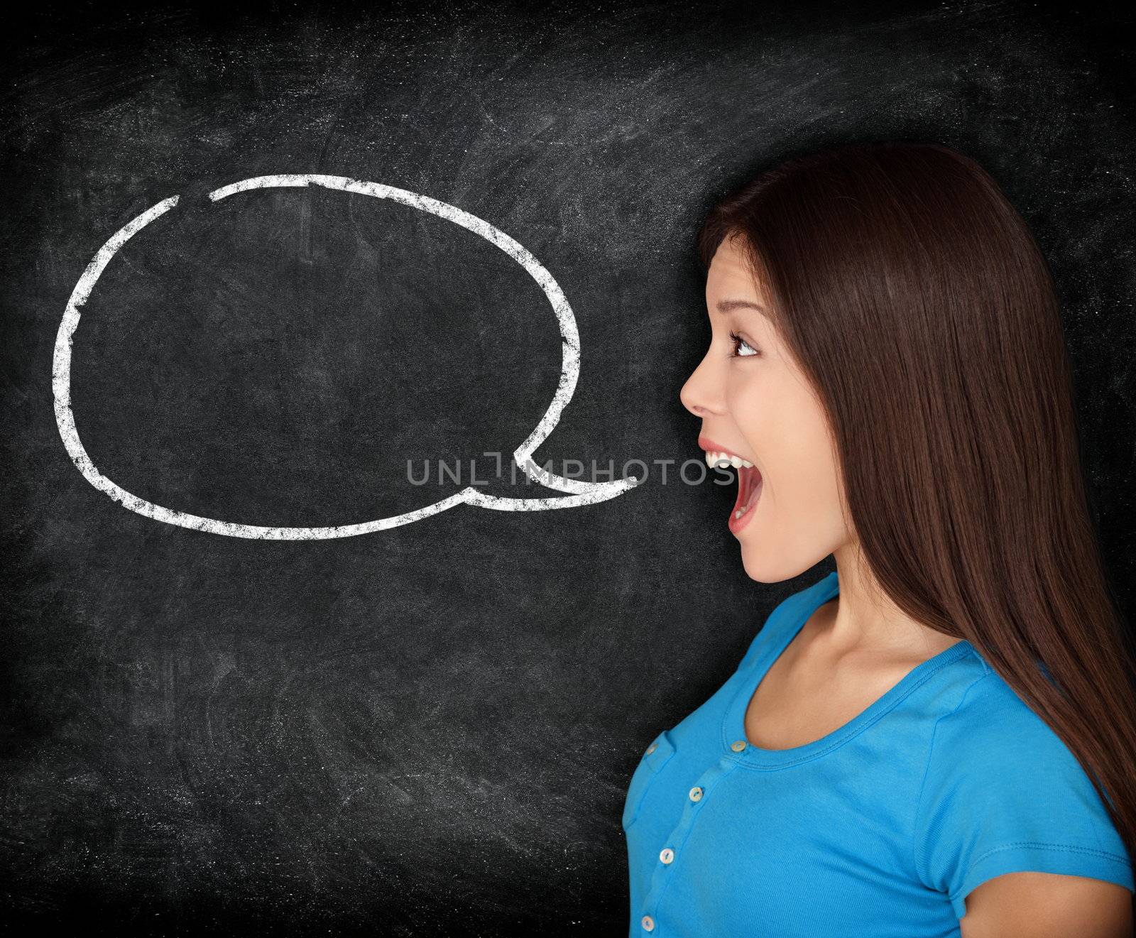 Speech bubble woman student blackboard. Woman talking in profile with black chalkboard texture as background. Funny image of mixed race female college student.